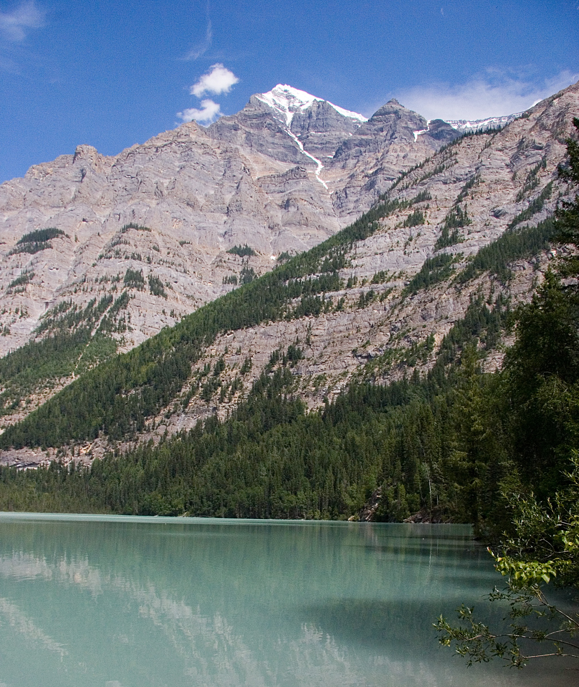 Turquoise water of Kinney Lake on the Berg Lake Trail beneath the south slopes of Whitehorn Mountain, Mount Robson Provincial Park