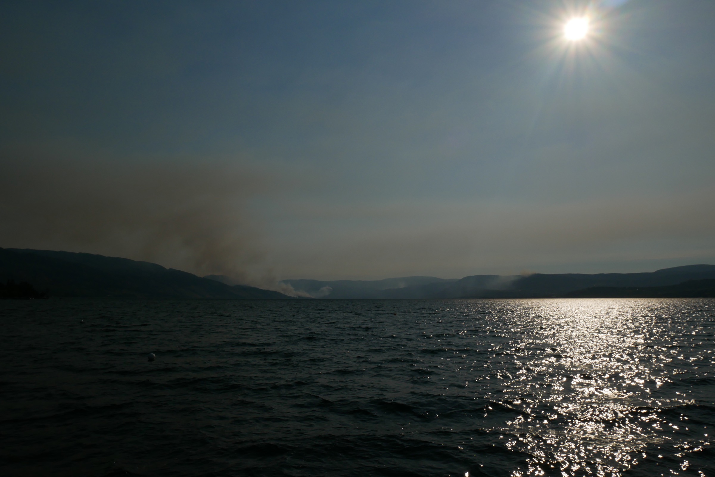 Wildfire smoke over the ridges of Okanagan Mountain Provincial Park in late afternoon