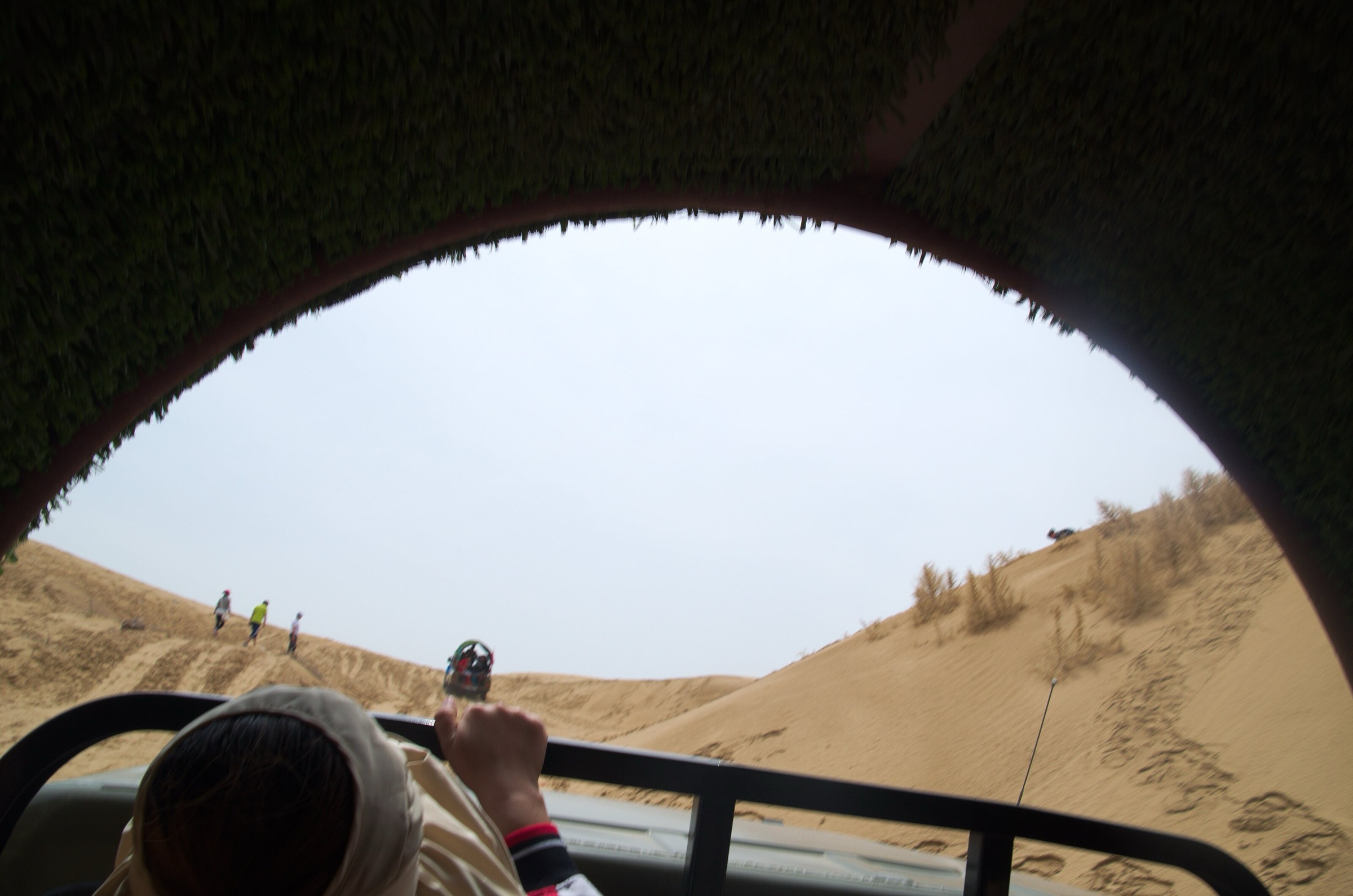 Vehicles crossing dune fields inside the Kubuqi Desert, Inner Mongolia