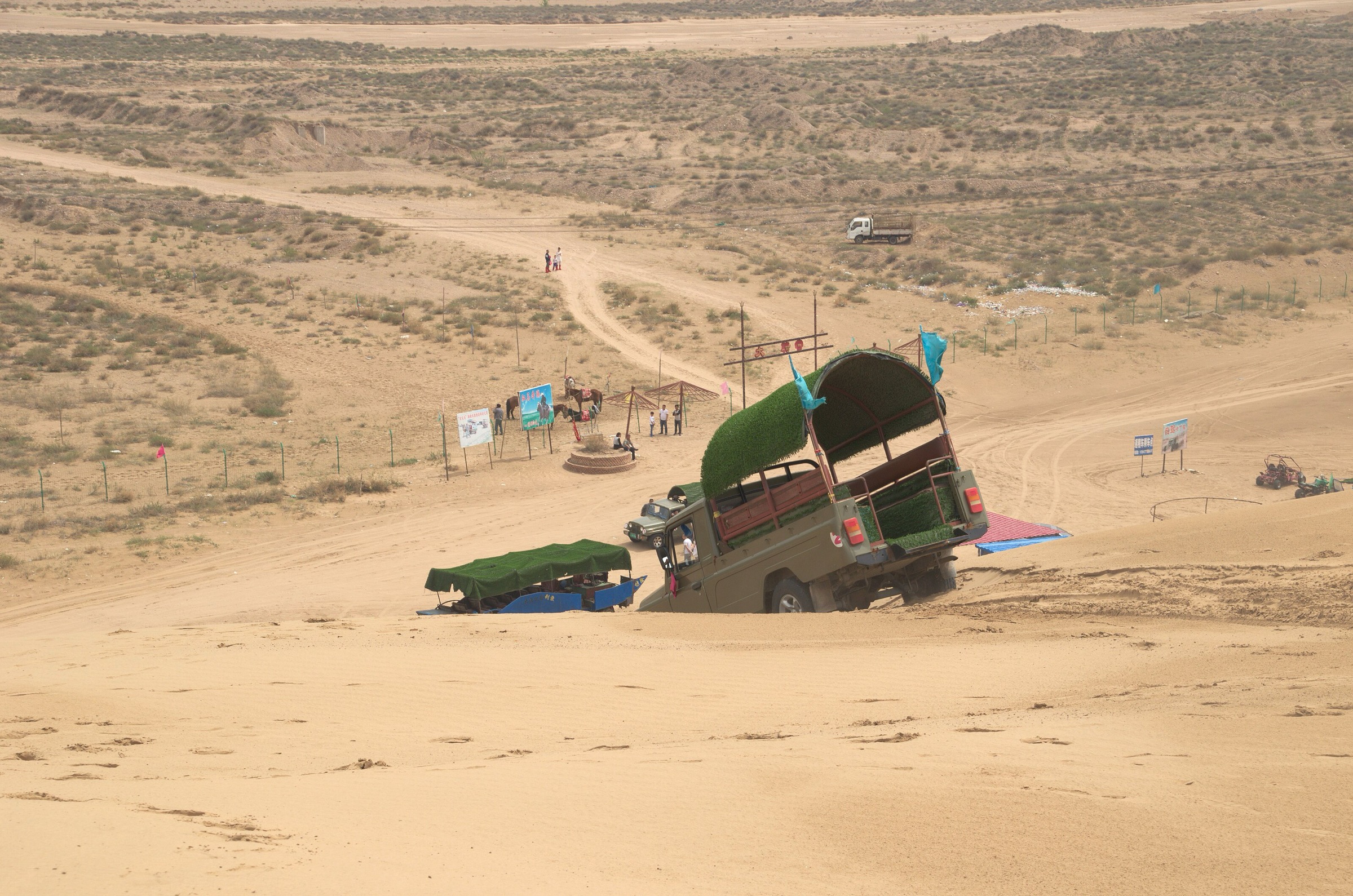 Off-road vehicle leaving the dune field on the western edge of the Kubuqi Desert