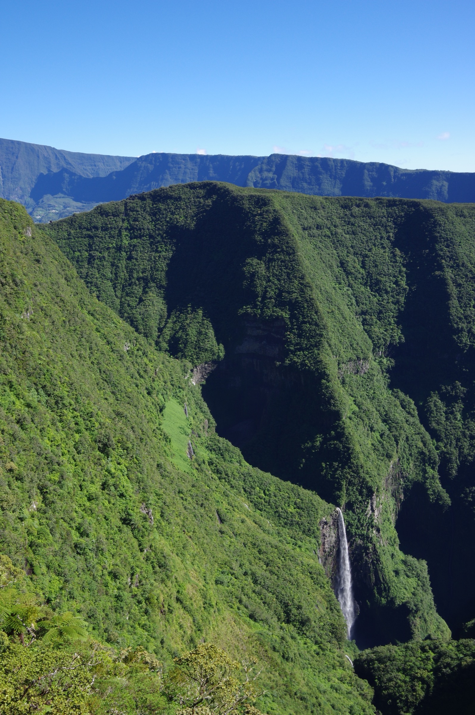 The Trou de Fer canyon seen from the Bélouve overlook, with multiple waterfalls plunging into a dense forest chasm