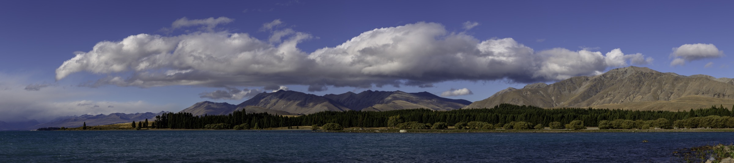 Large panorama sur le lac Pukaki avec la chaîne du Ben Ōhau et Aoraki / Mount Cook en tête du lac