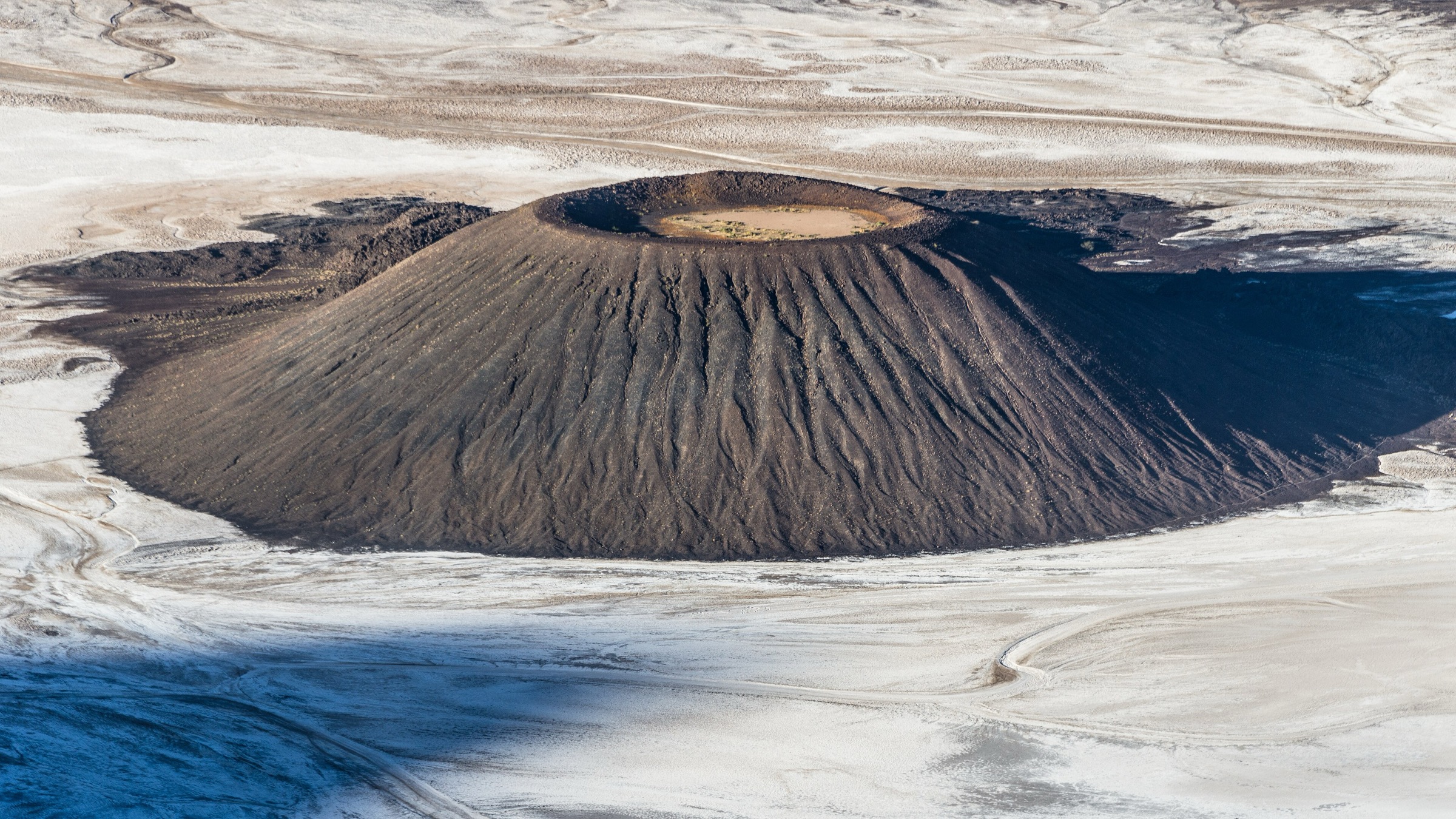 Trou au Natron volcanic depression with white natron floor, Tibesti Mountains, Chad