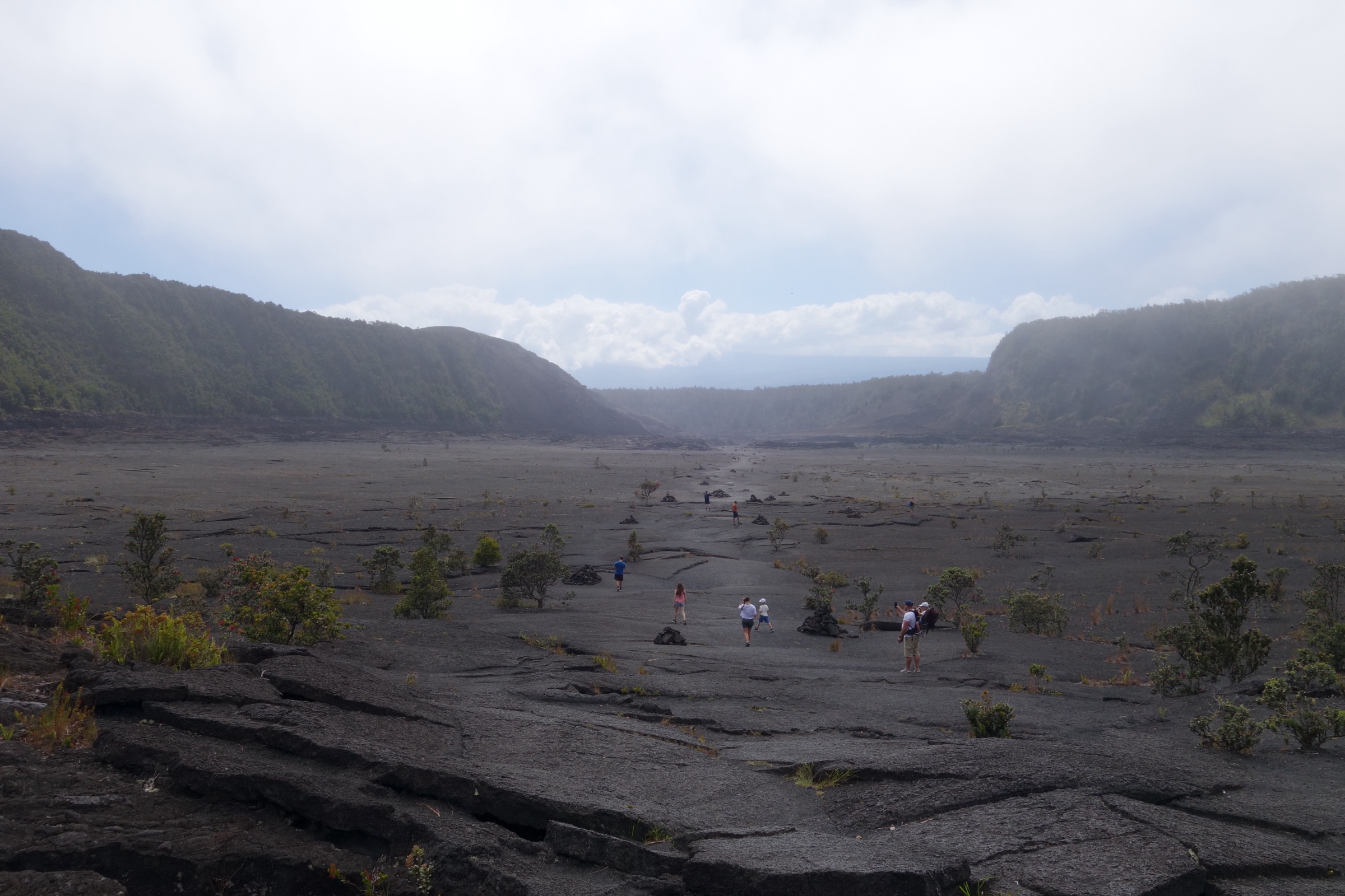 Hikers crossing the solidified 1959 lava lake on the Kīlauea Iki crater floor