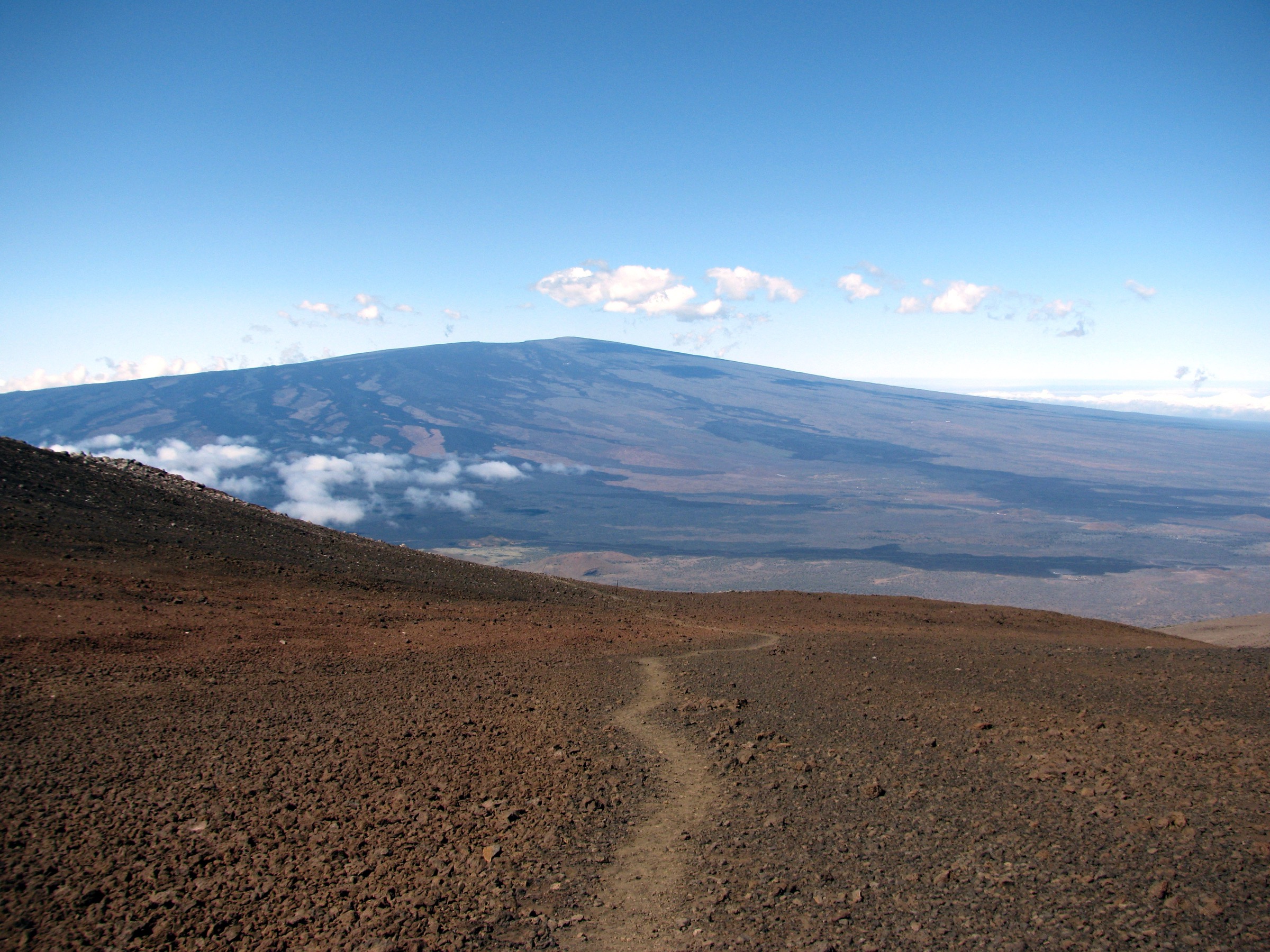 Mauna Loa seen from the north-east, showing the broad open-lava upper flank crossed by the Observatory Trail