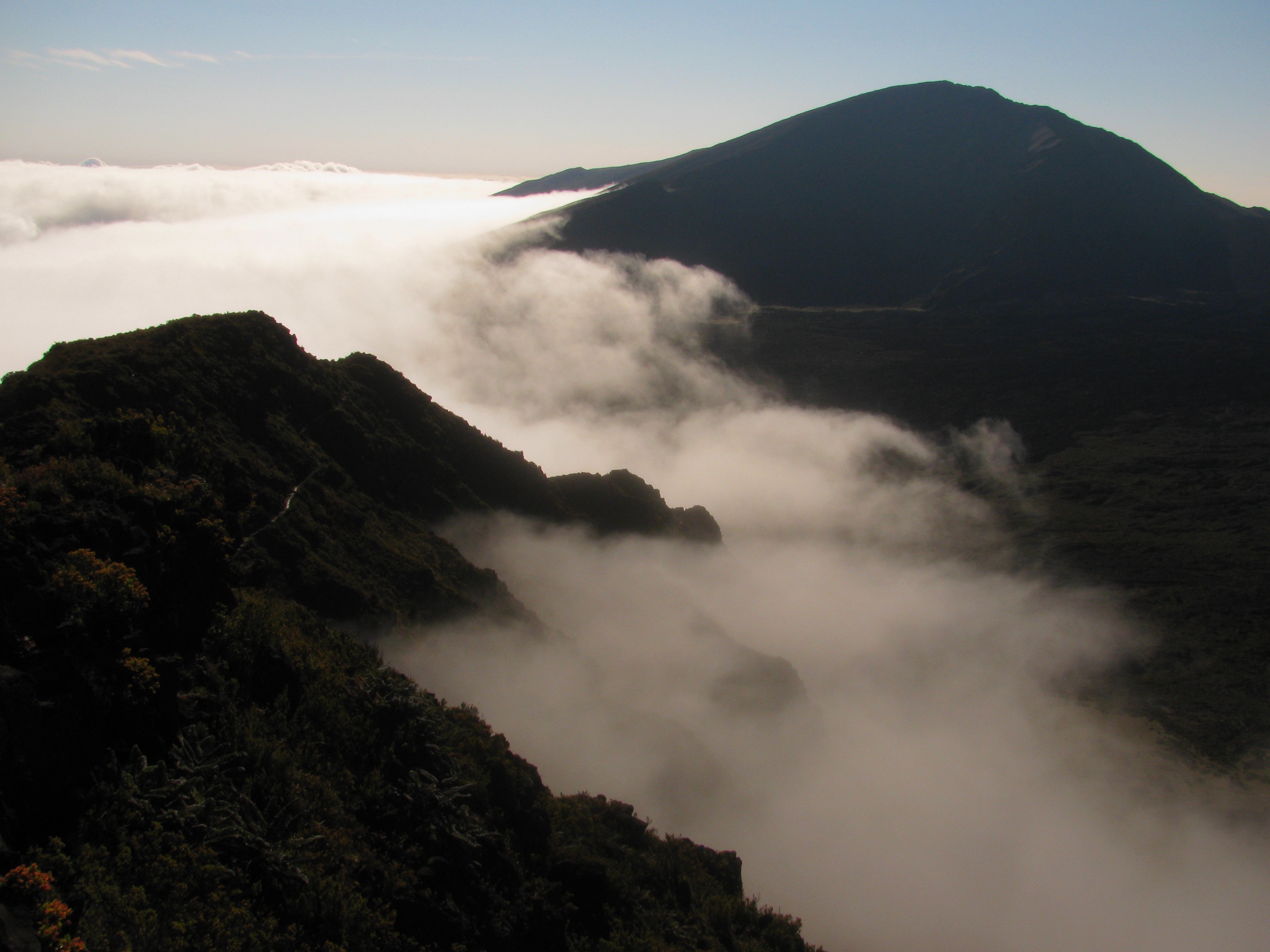 View from the Halemauʻu Trail across clouds in the Koʻolau Gap toward Hanakauhi