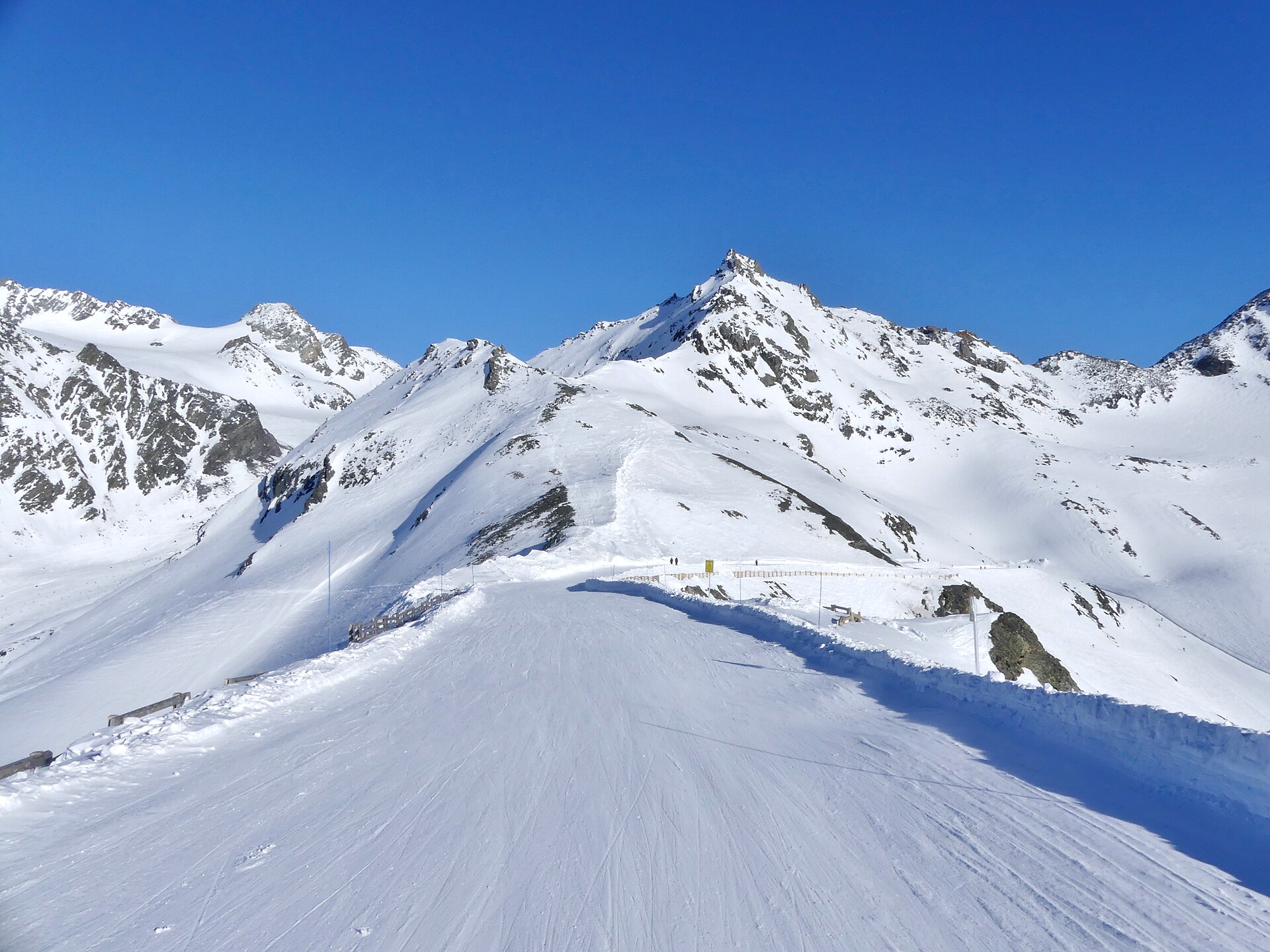 The snow-covered Col du Bouchet between Val Thorens and Orelle under blue sky