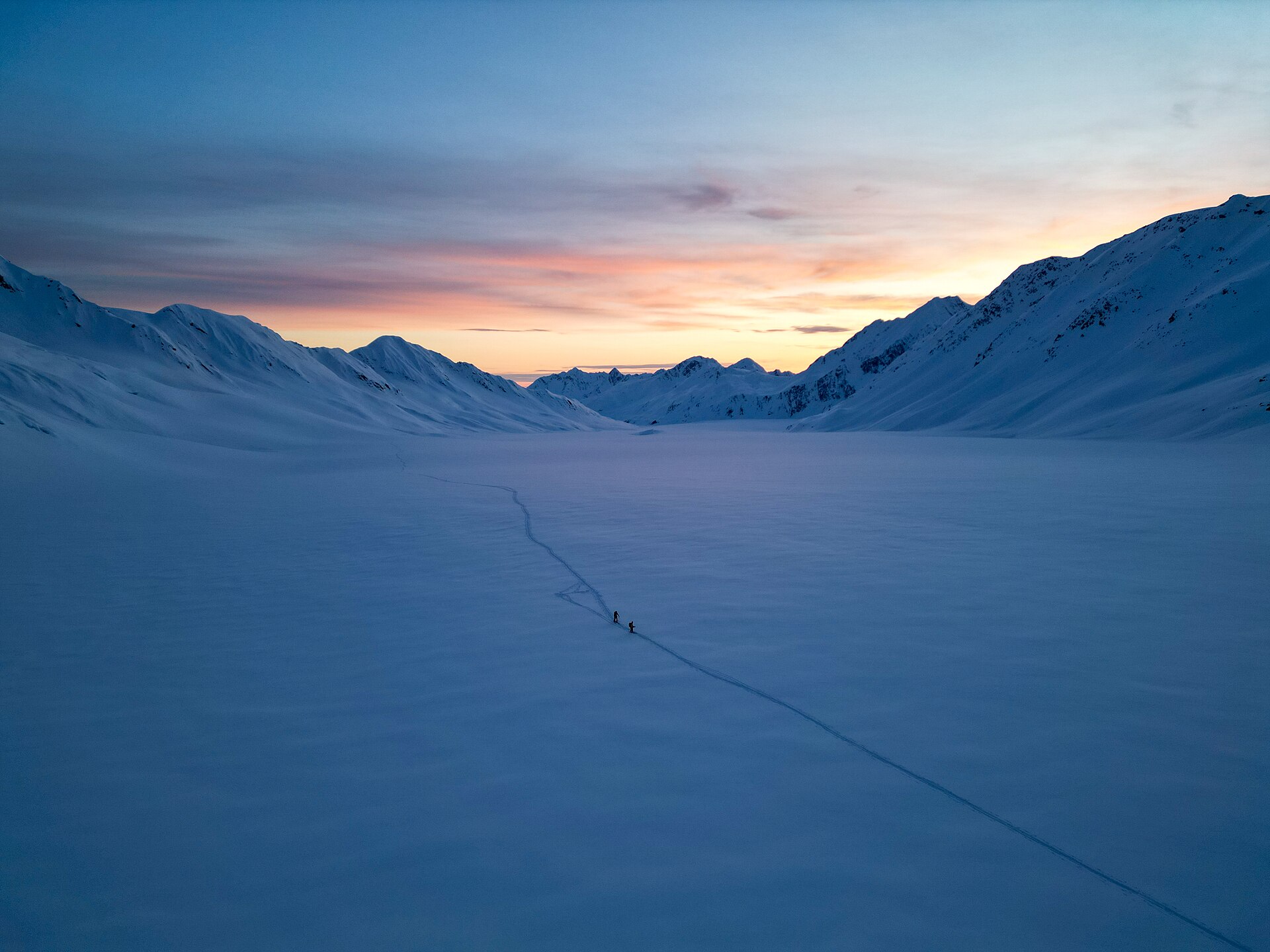 A skier descending a steep snow ridge above Valdez in the Chugach Mountains