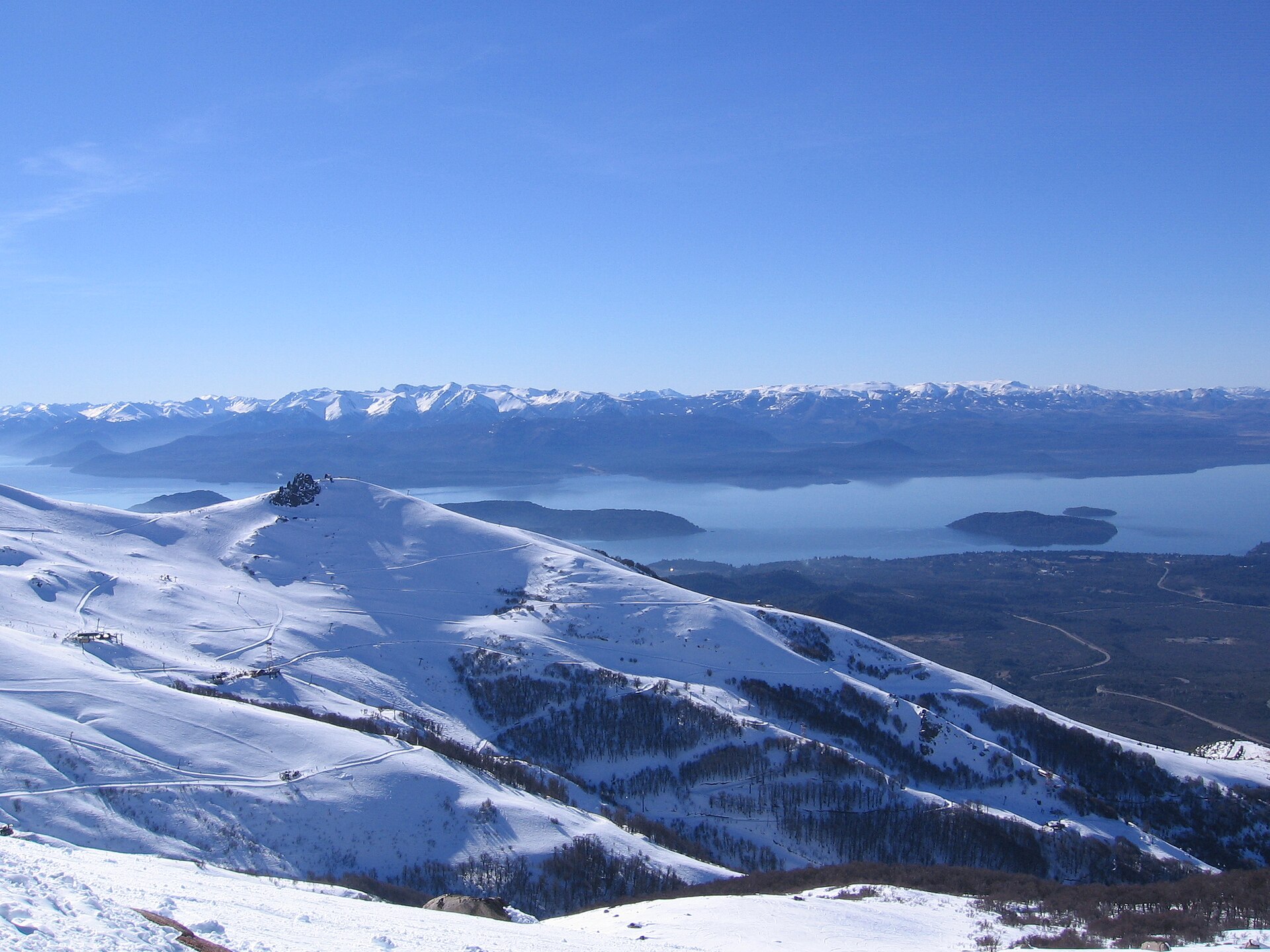 Les crêtes enneigées du Cerro Catedral au-dessus des lacs bleus de Patagonie