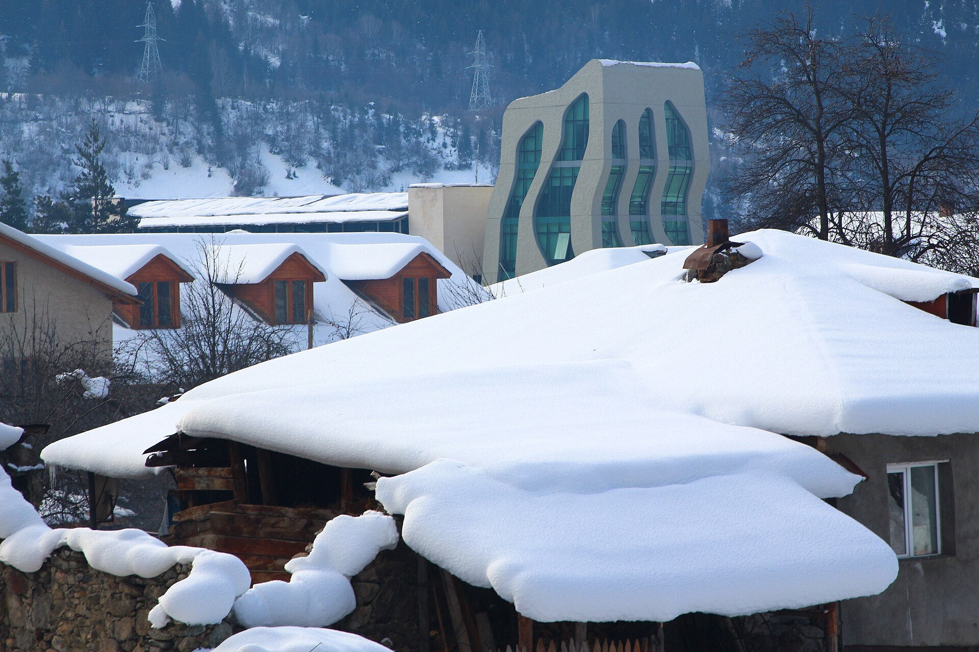 Traditional roofs in Mestia carrying deep winter snow