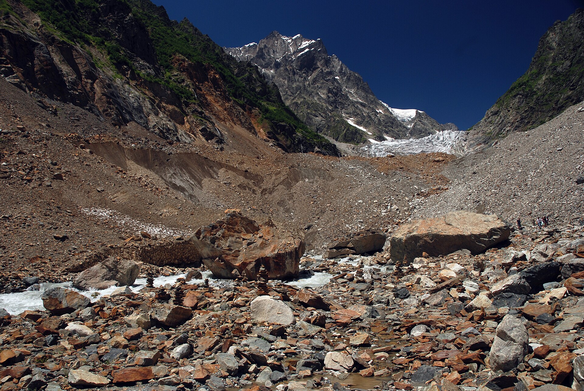 Chalaadi Glacier descending beneath the rocky summit of Chatintau in Svaneti