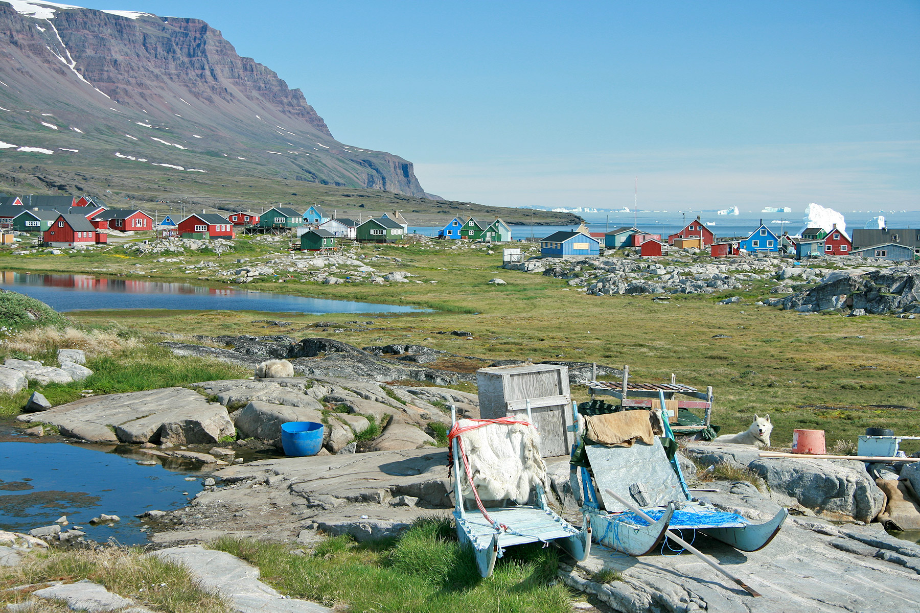 Qeqertarsuaq's colourful houses beneath the flat-topped volcanic mountains of Disko Island