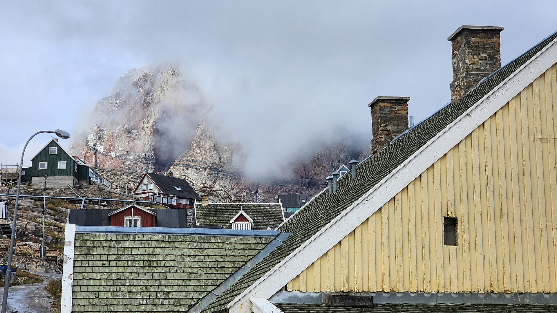The sheer profile of Uummannaq mountain rising behind the settlement