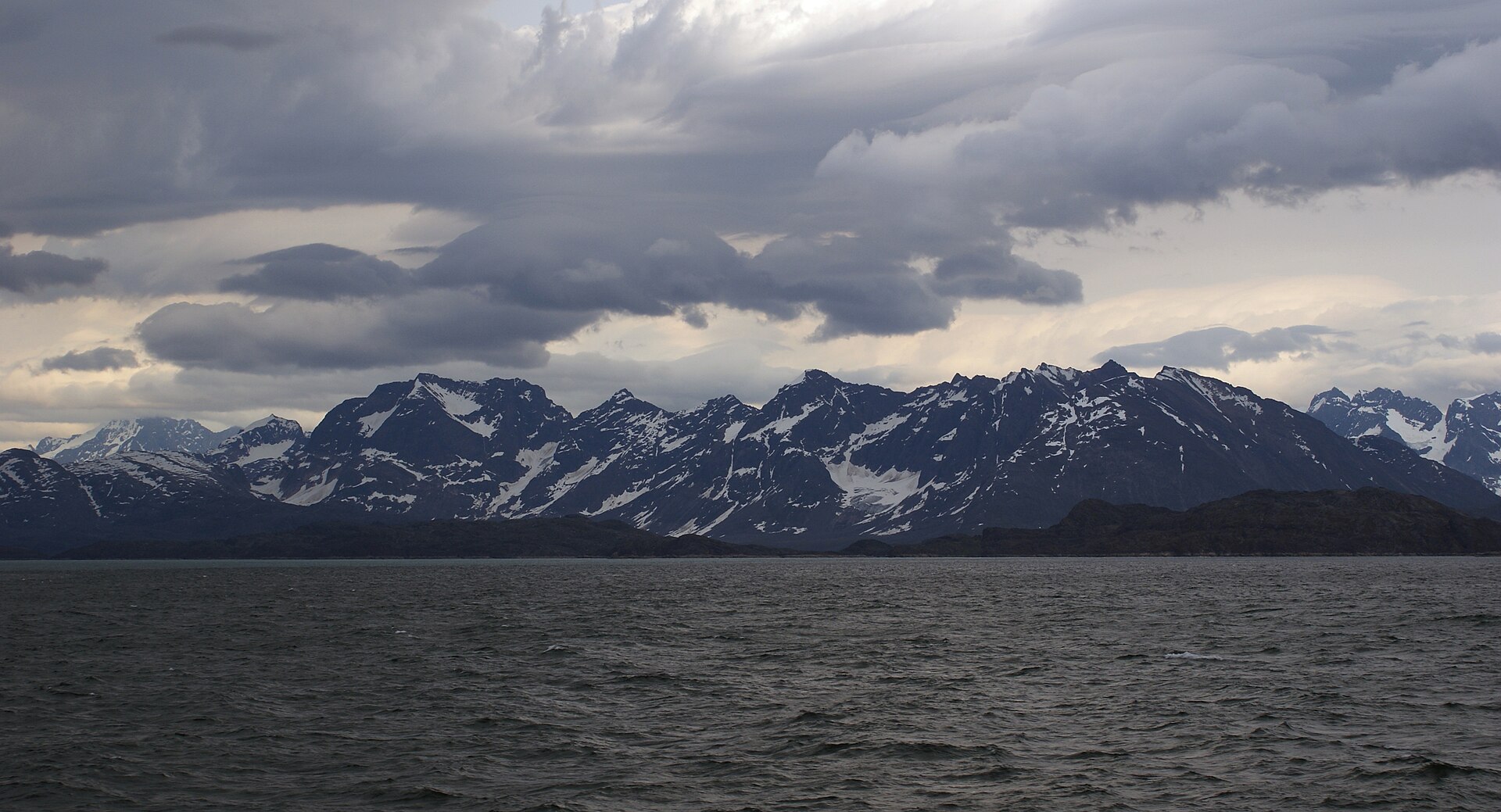 Steep mountains rising directly from Kangerlussuatsiaq Fjord in West Greenland