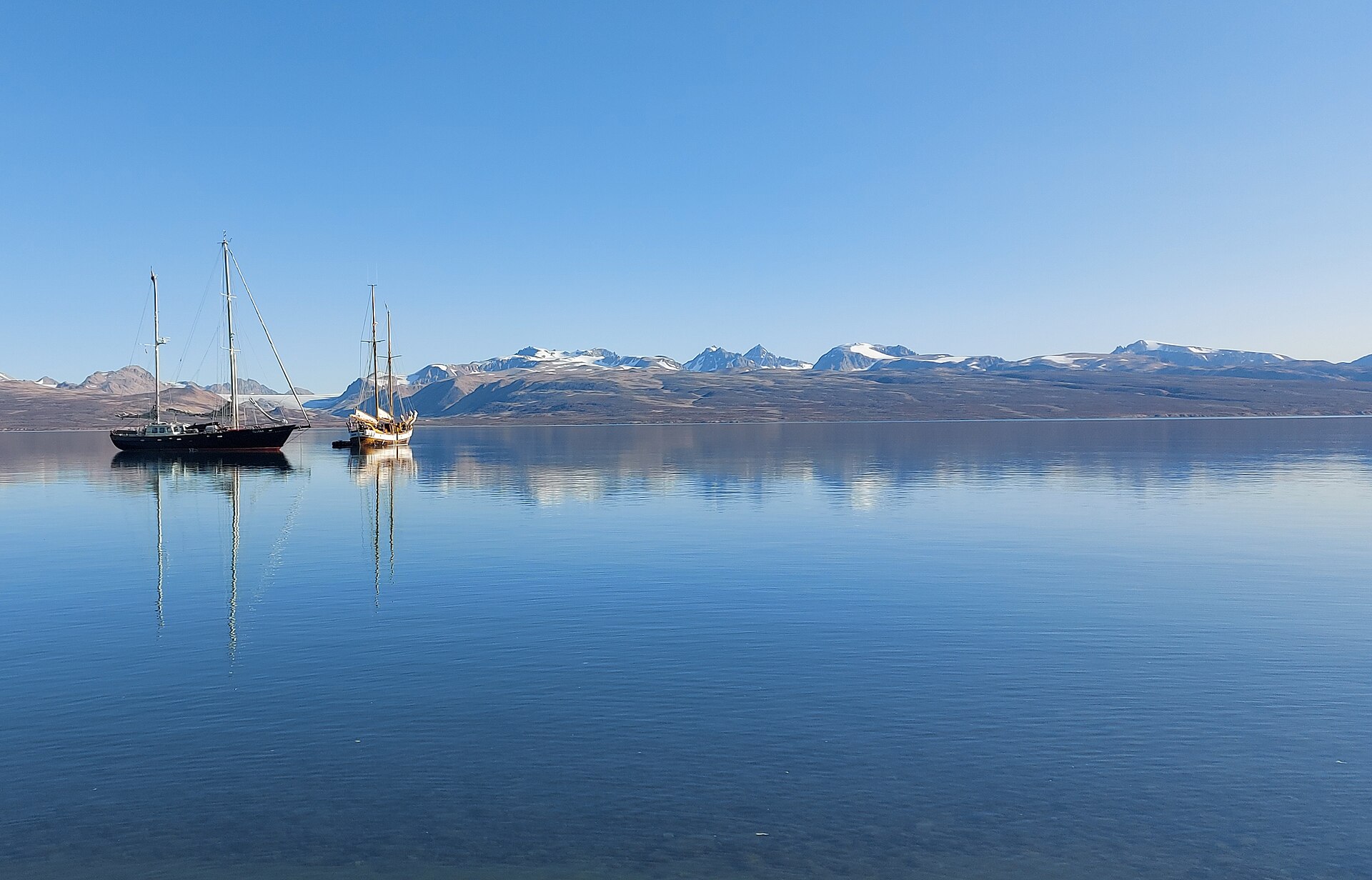 Two sailing vessels on Hurry Inlet beneath the mountains of Liverpool Land