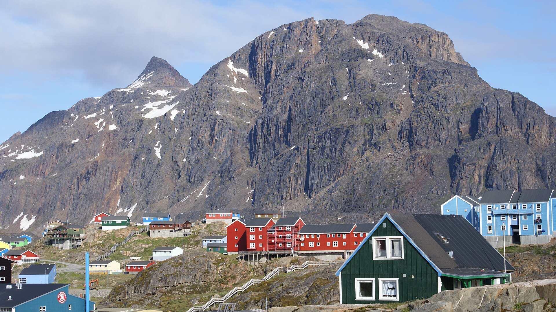 The steep summit of Nasaasaaq rising above colourful houses in Sisimiut