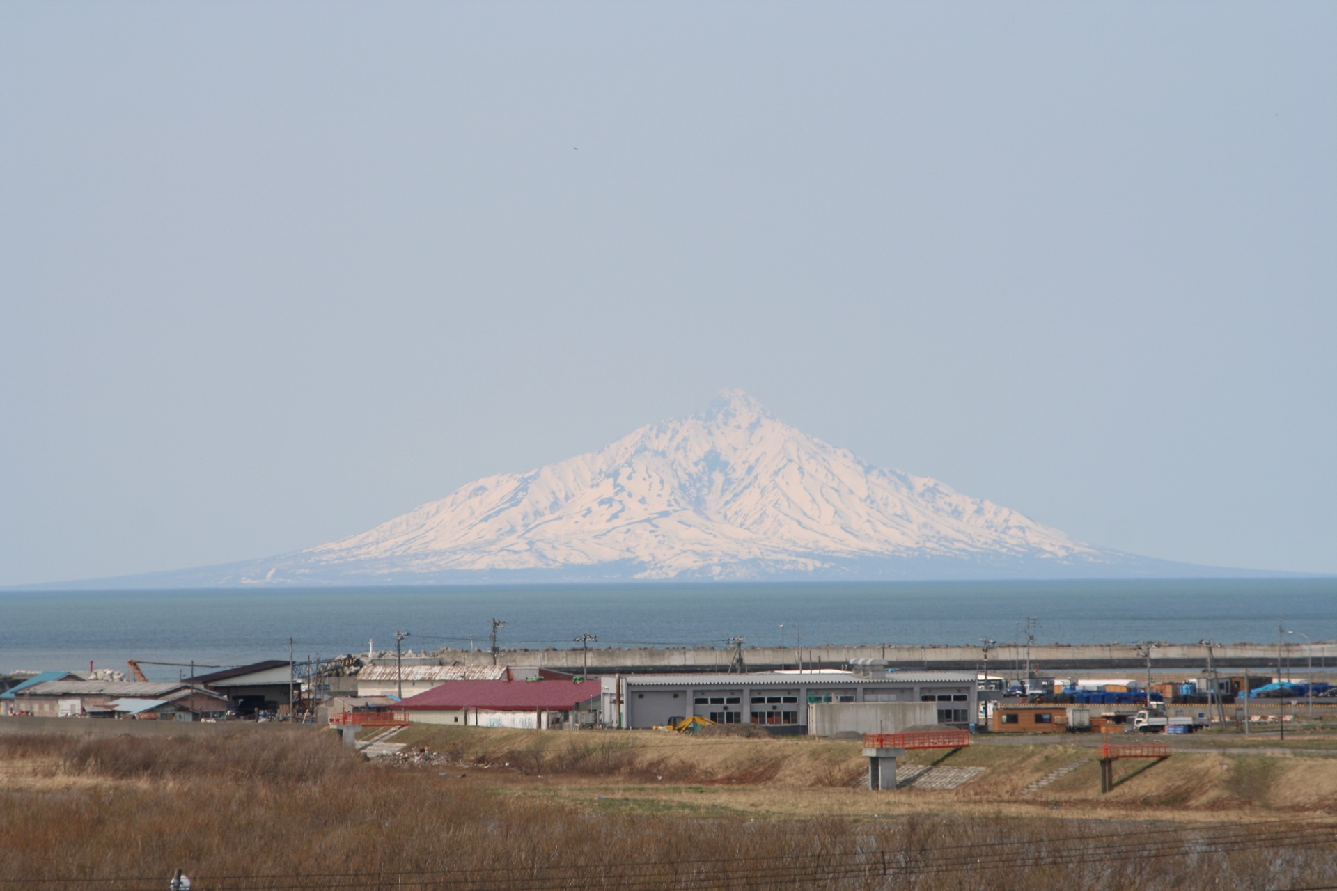 Mount Rishiri rising across the sea with snow streaking its upper gullies