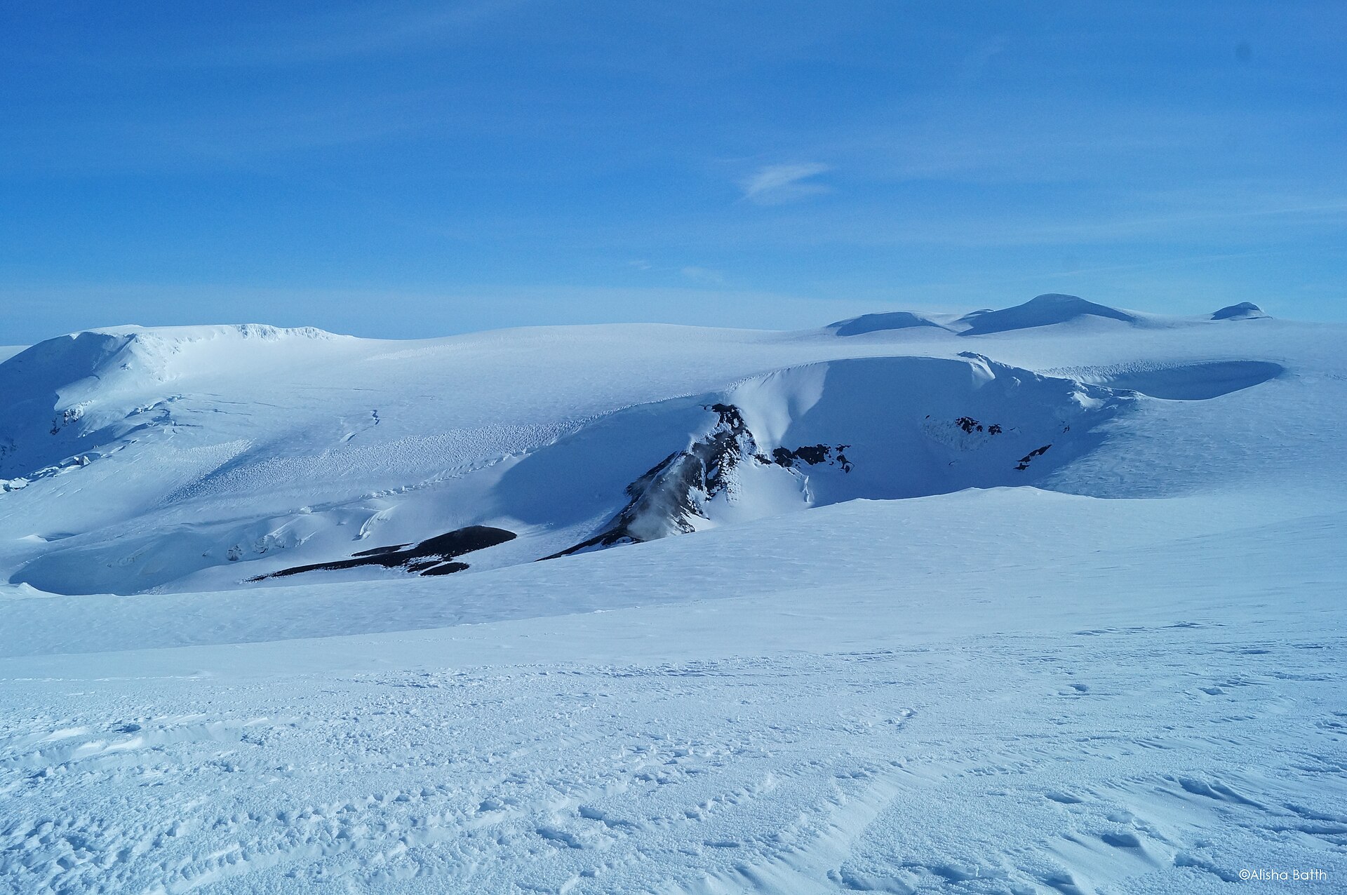 A skier-sized figure crossing the snowy Eyjafjallajökull crater