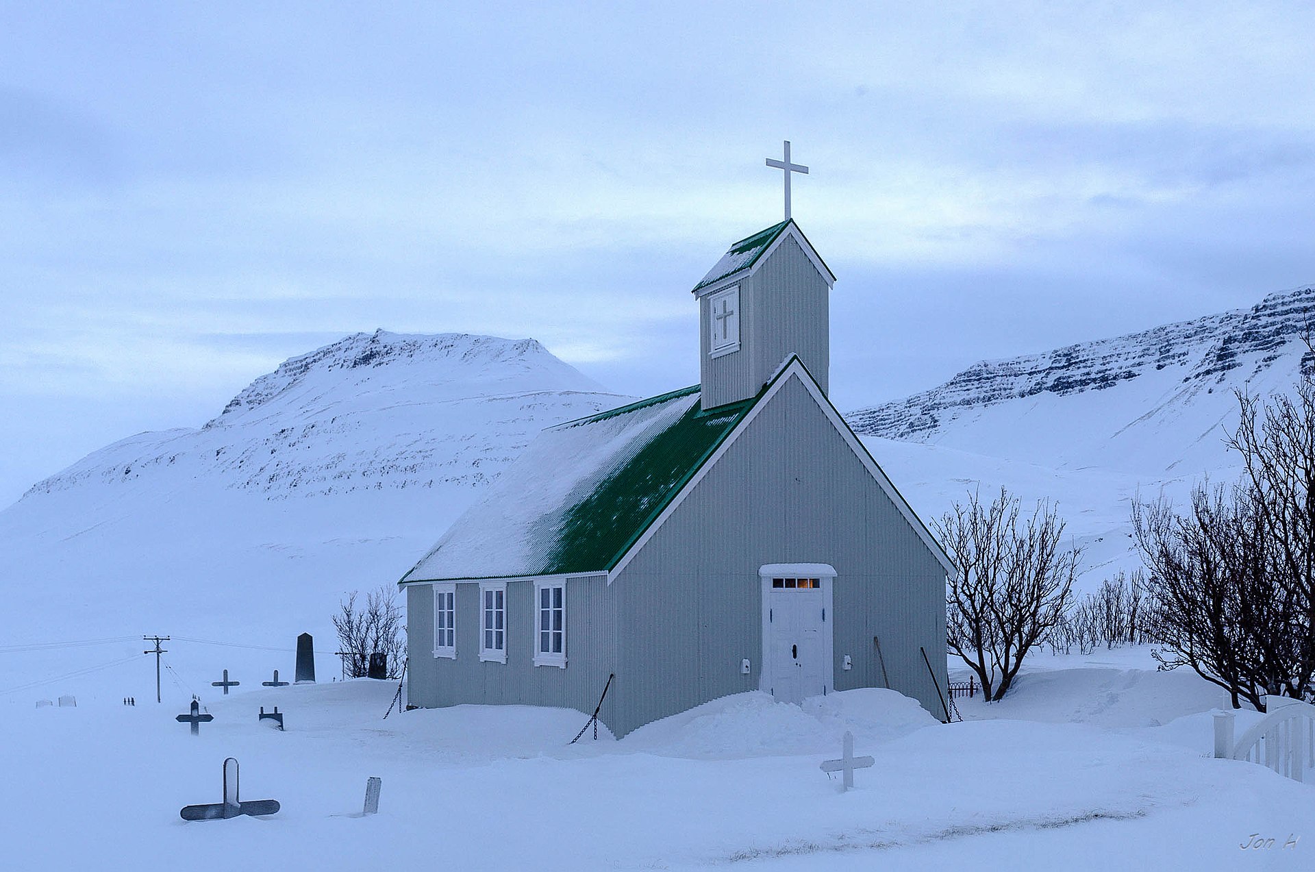 Staðarkirkja church surrounded by deep snow in Súgandafjörður