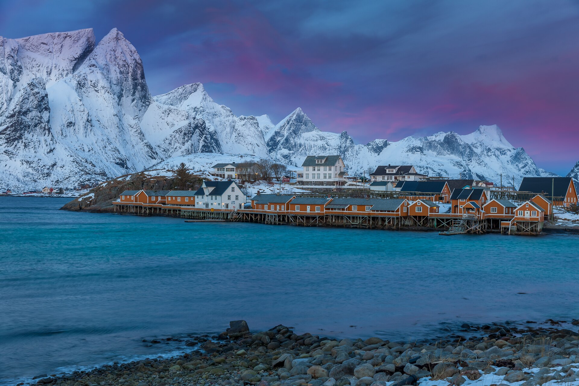 Sakrisøy fishing village beneath snow-covered mountains in Lofoten