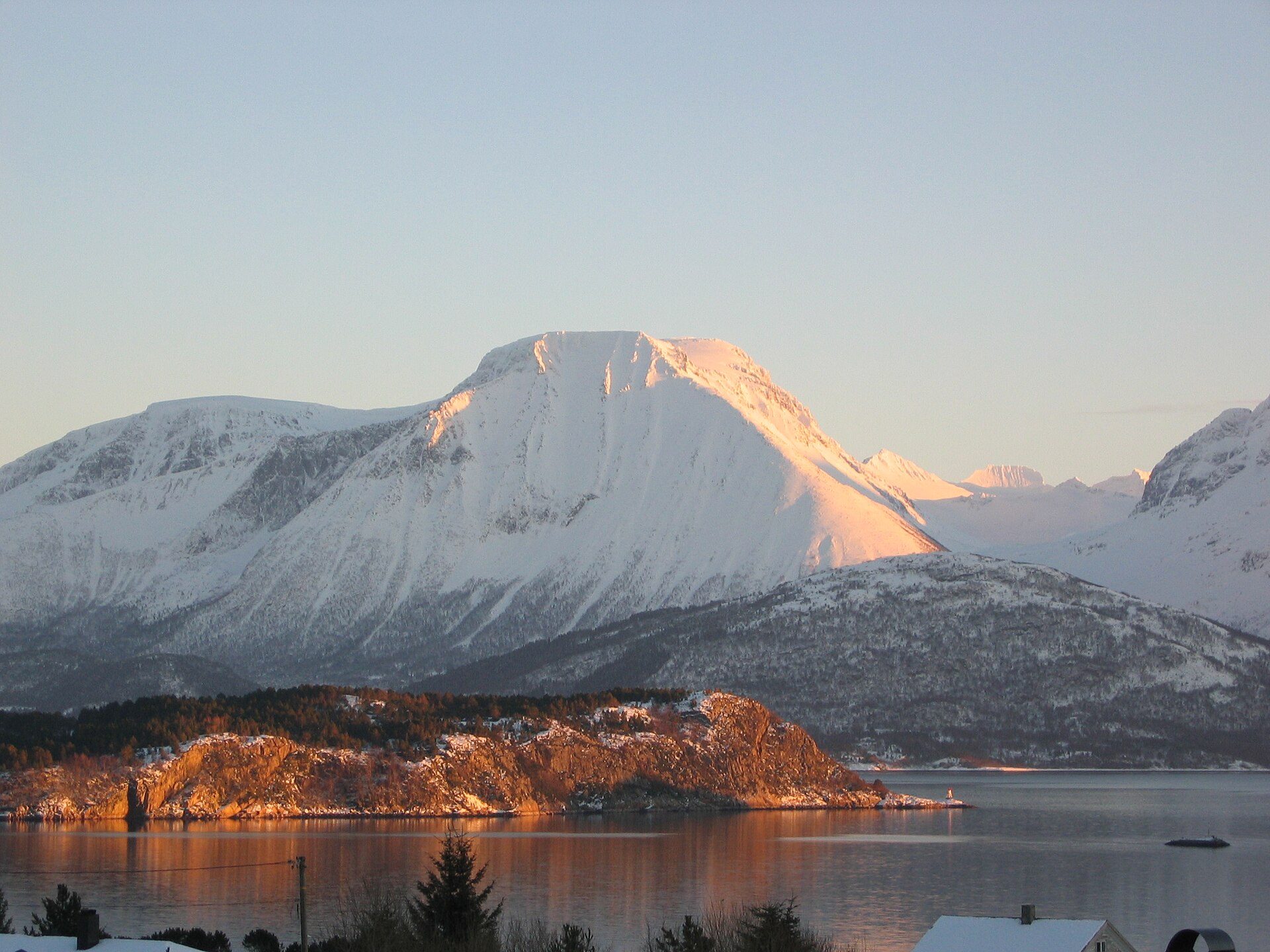 Low winter sunlight on a snowy mountain in the Sunnmøre Alps