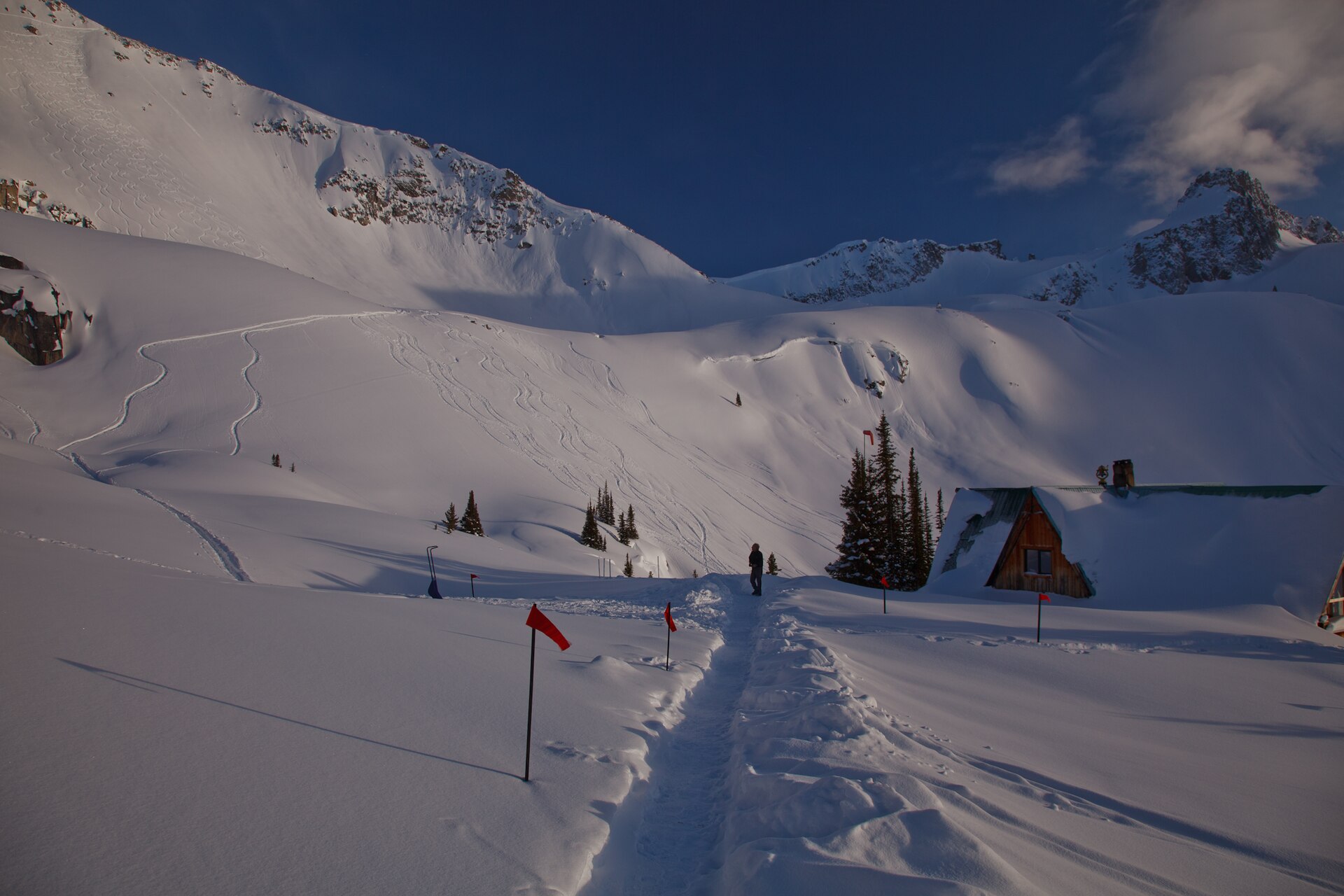 Un lodge hors-piste isolé au pied des monts Selkirk enneigés, au crépuscule