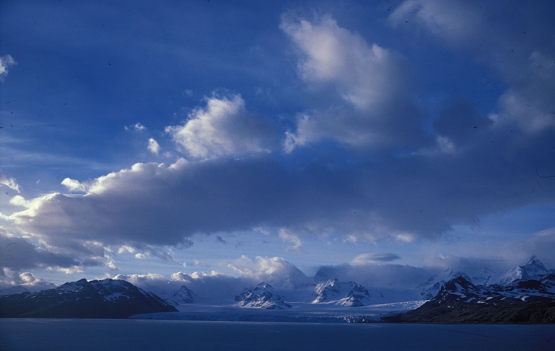 Evening light and cloud over the snowy mountains of Cumberland Bay