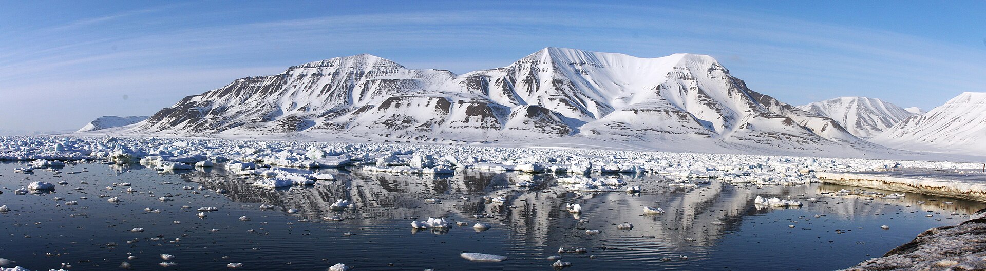 Panorama across Adventfjorden to snow-striped mountains near Longyearbyen