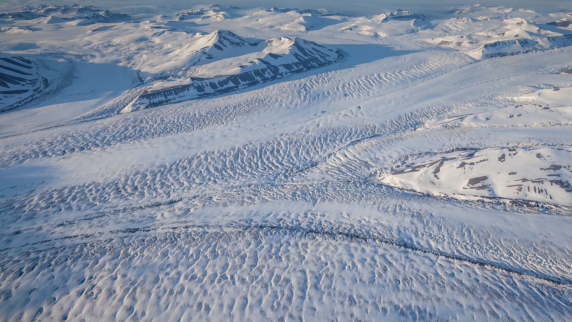 Vast crevassed Nathorst glacier and Arctic mountains under midnight light
