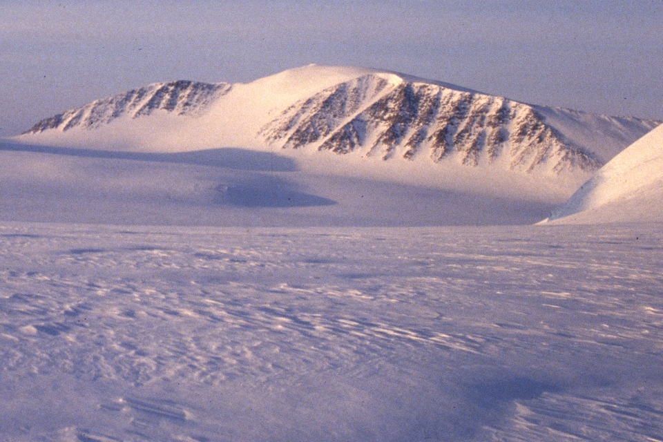 Newtontoppen rising above a broad snow-covered glacier in Svalbard