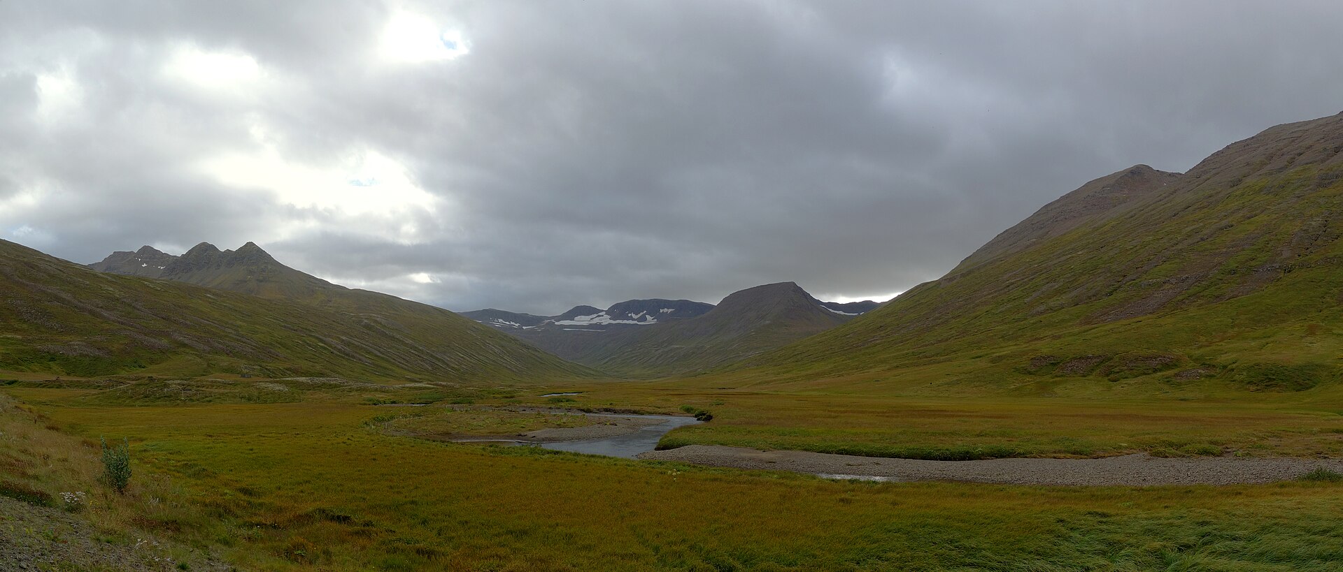 Clouds breaking over the broad upper valley of Héðinsfjörður