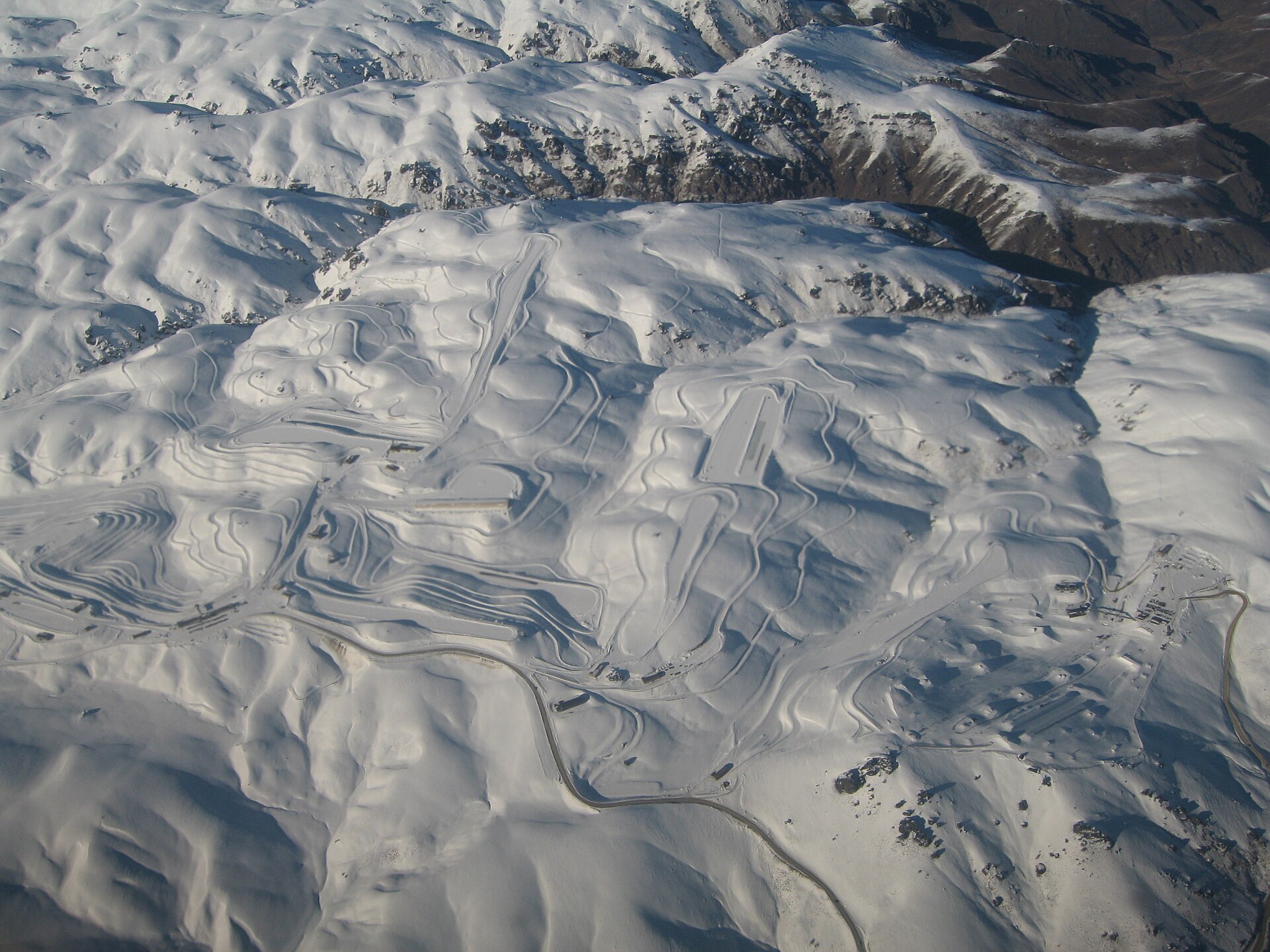 Aerial view of Snow Farm and snow-covered basins in the Pisa Range