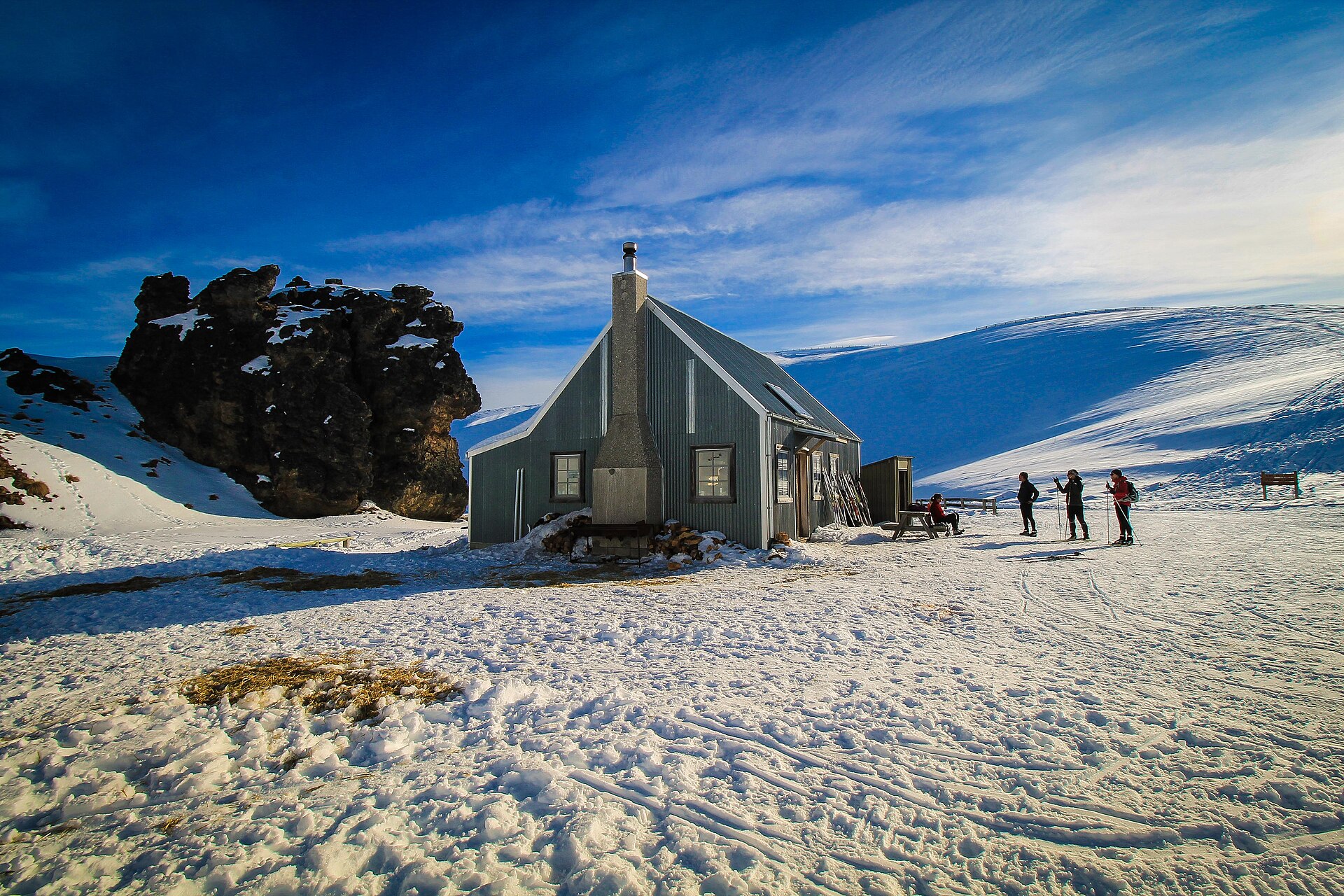 Meadow Hut and skiers on the snowy Snow Farm plateau