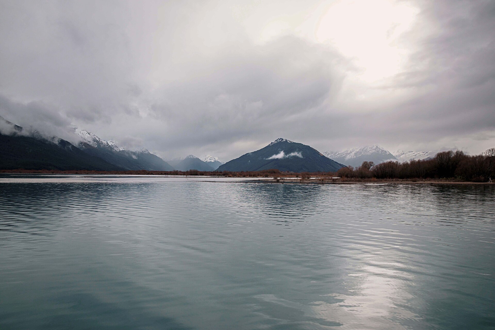 Lake Wānaka beneath low cloud and snow-covered mountains