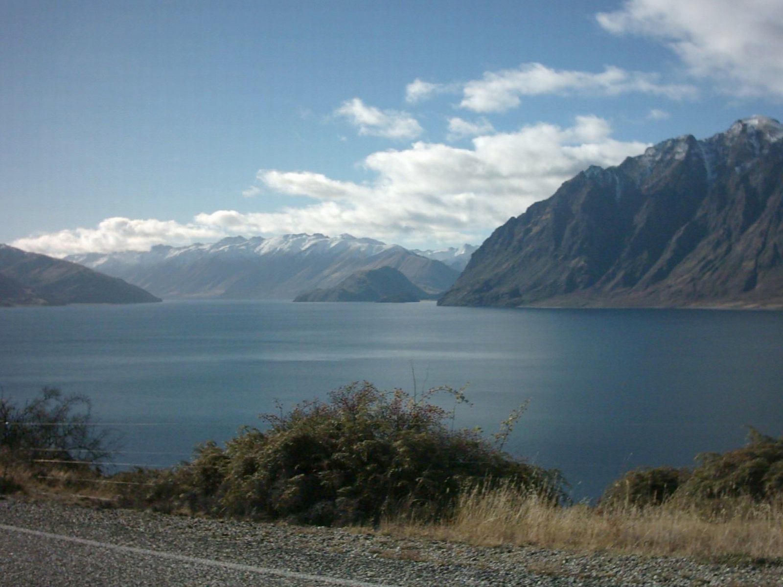 Lake Hāwea and its snow-covered mountains on a calm winter day