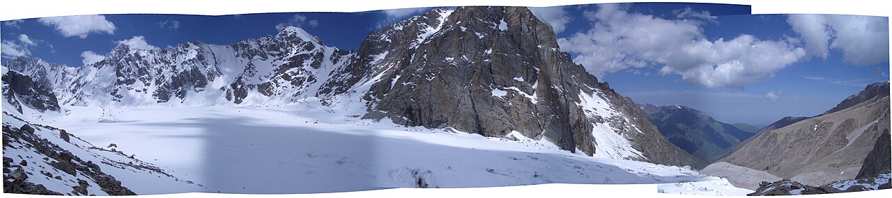 A wide panorama of glacier and sharp peaks high above Ala-Archa