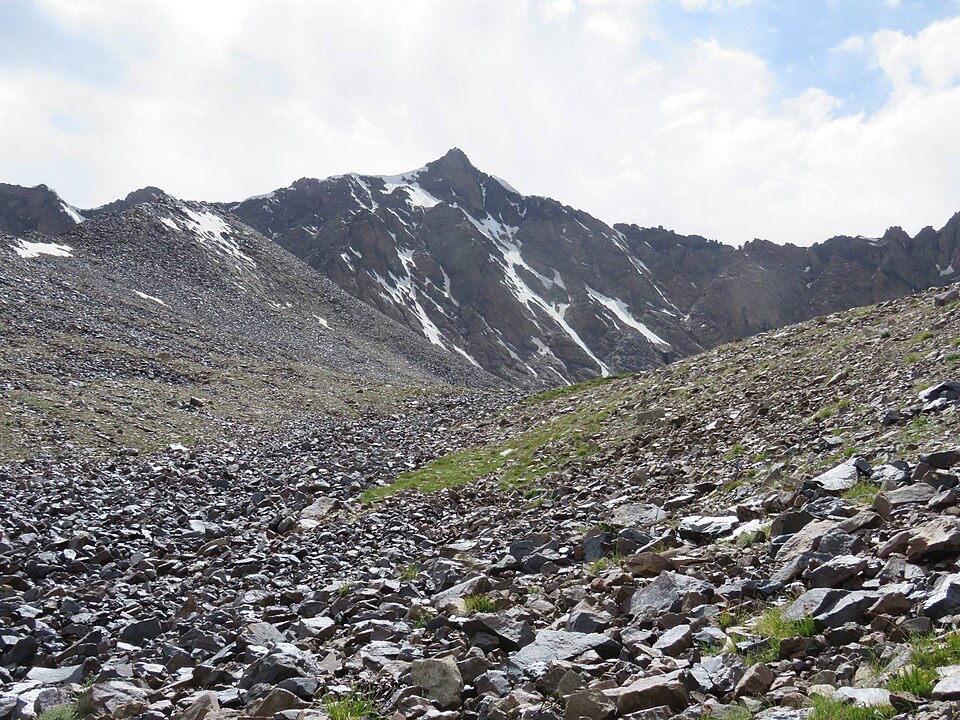 Rocky slopes and lingering snow at East Bazar-Dara Pass at 4,600 metres