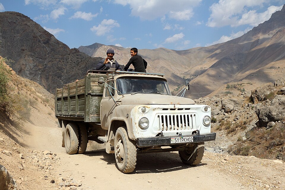 A Soviet-era GAZ truck carrying passengers on a rough Fann mountain road