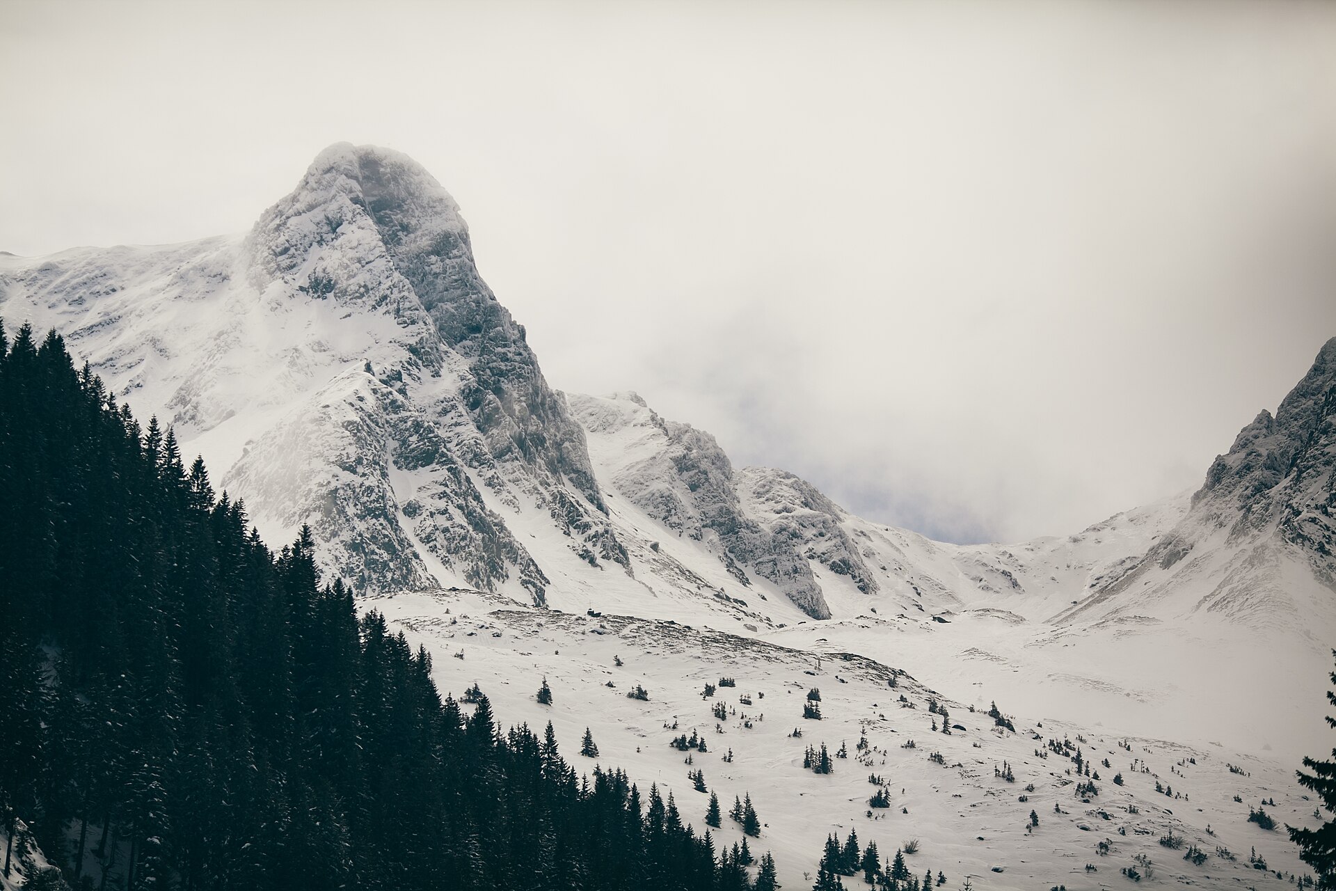 A steep Făgăraș peak covered in snow and cloud
