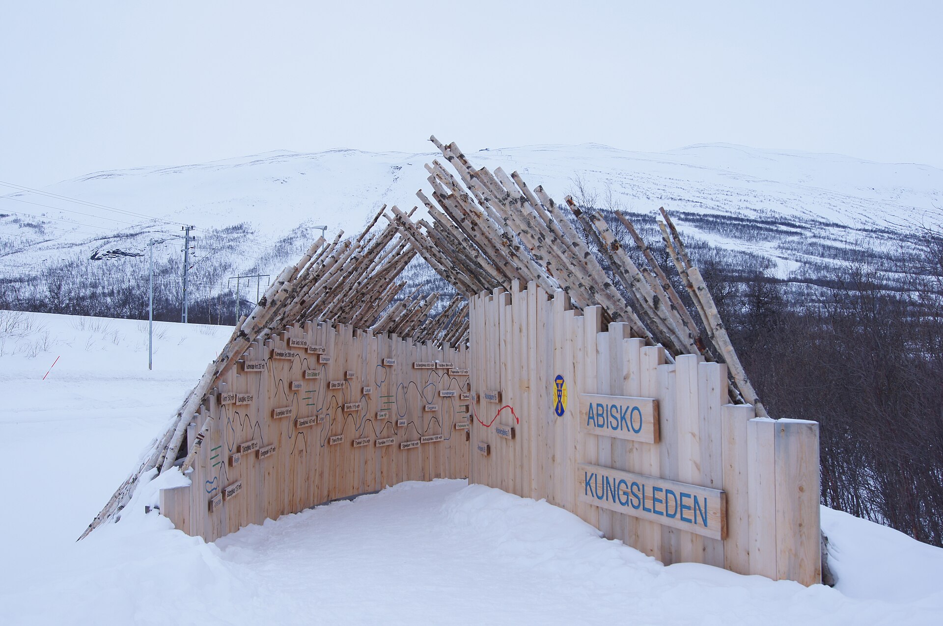 A snow-covered Kungsleden trail gateway at Abisko