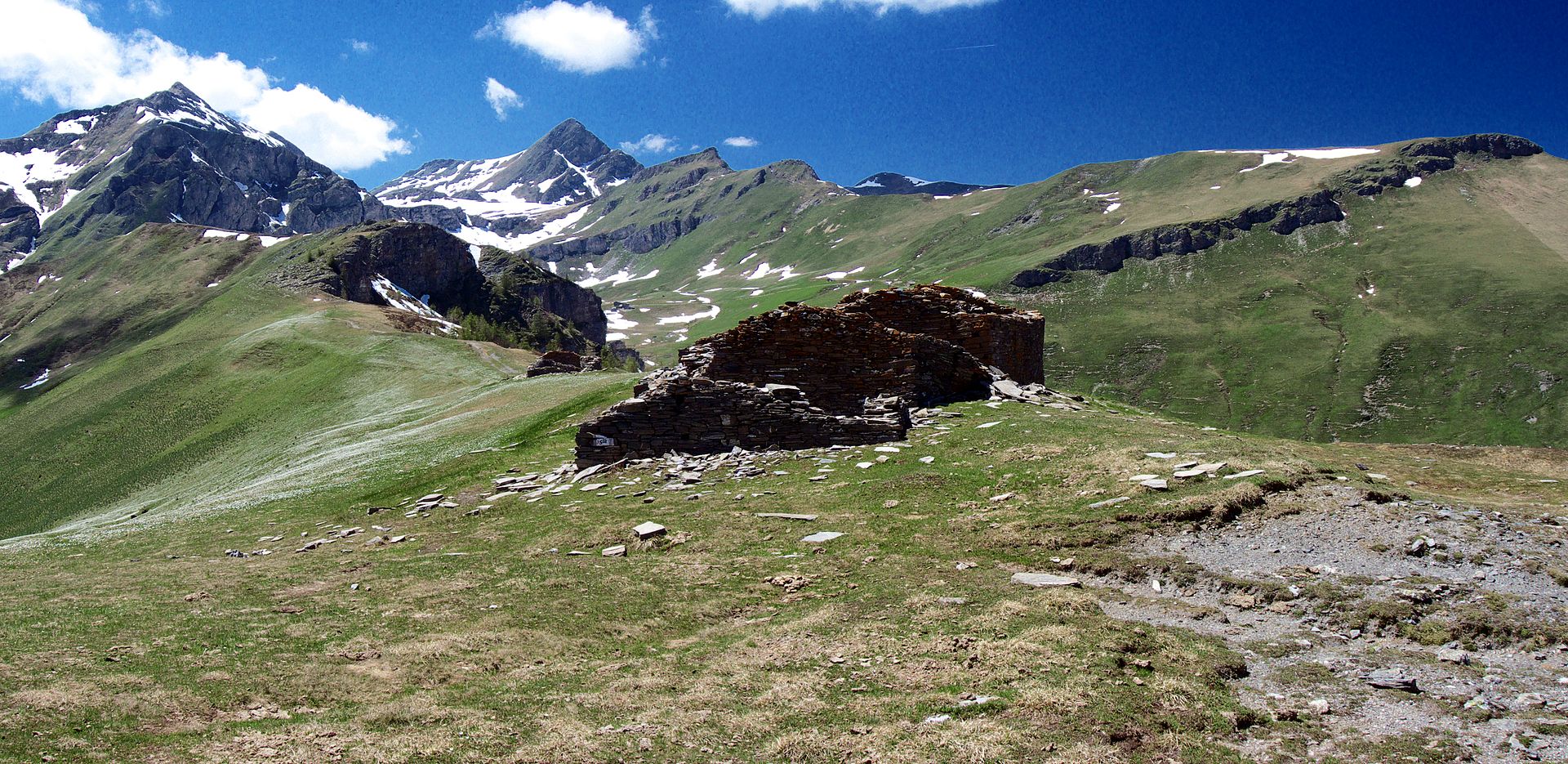 High pasture and stone ruins near Bassa di Narbona in Valle Maira