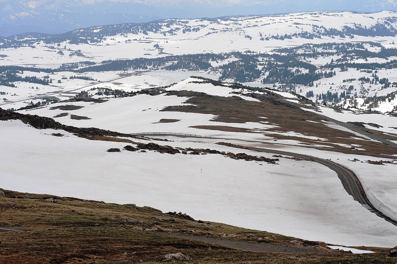 The Beartooth Highway winding through deep snow at the west summit