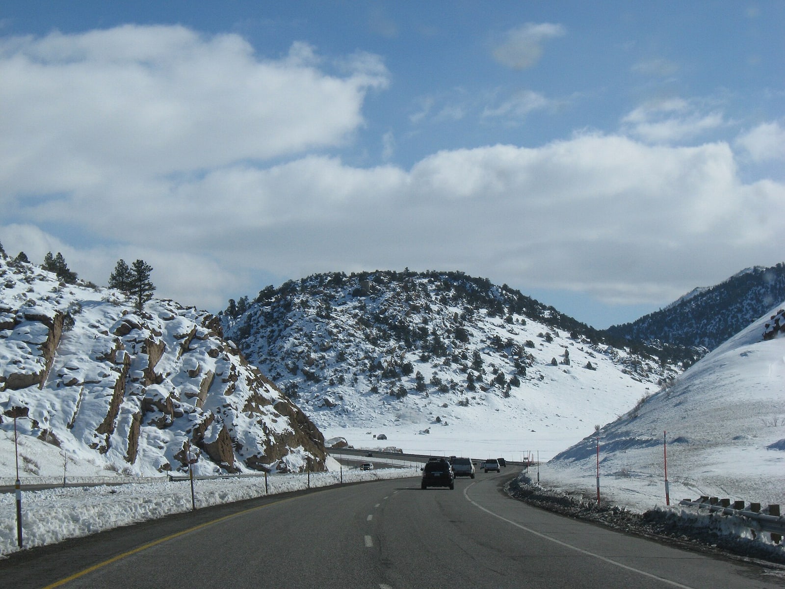 US Route 395 winding through snow-covered terrain between Mammoth and Bishop