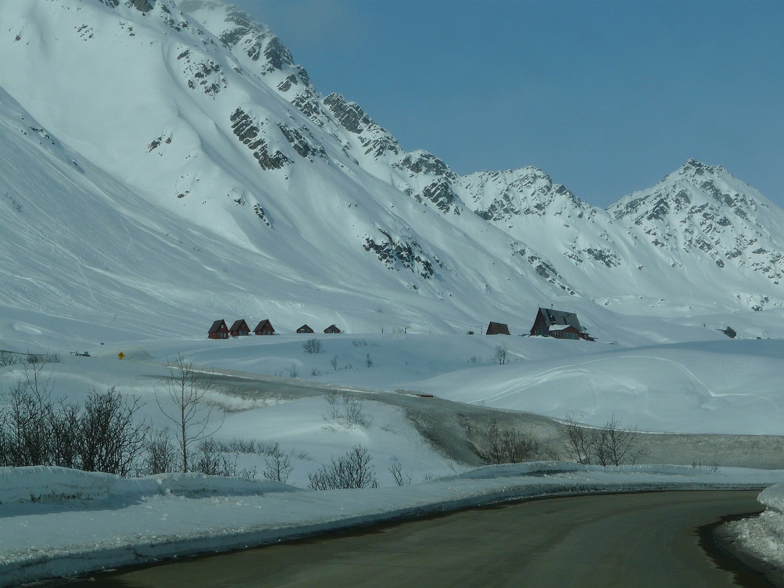 A snow-covered mountain road winding through Hatcher Pass