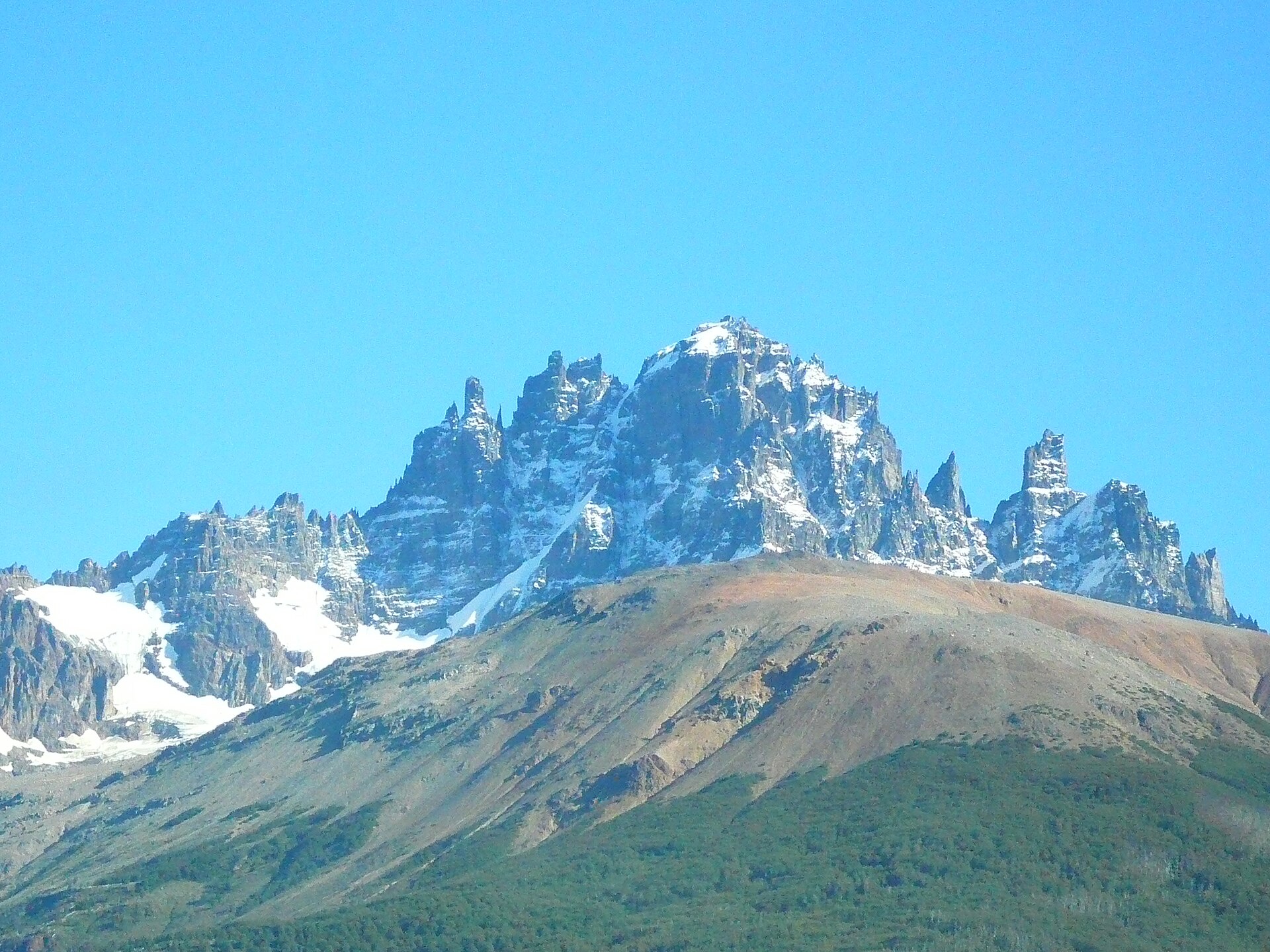 The dark spires of Cerro Castillo rising above snowfields