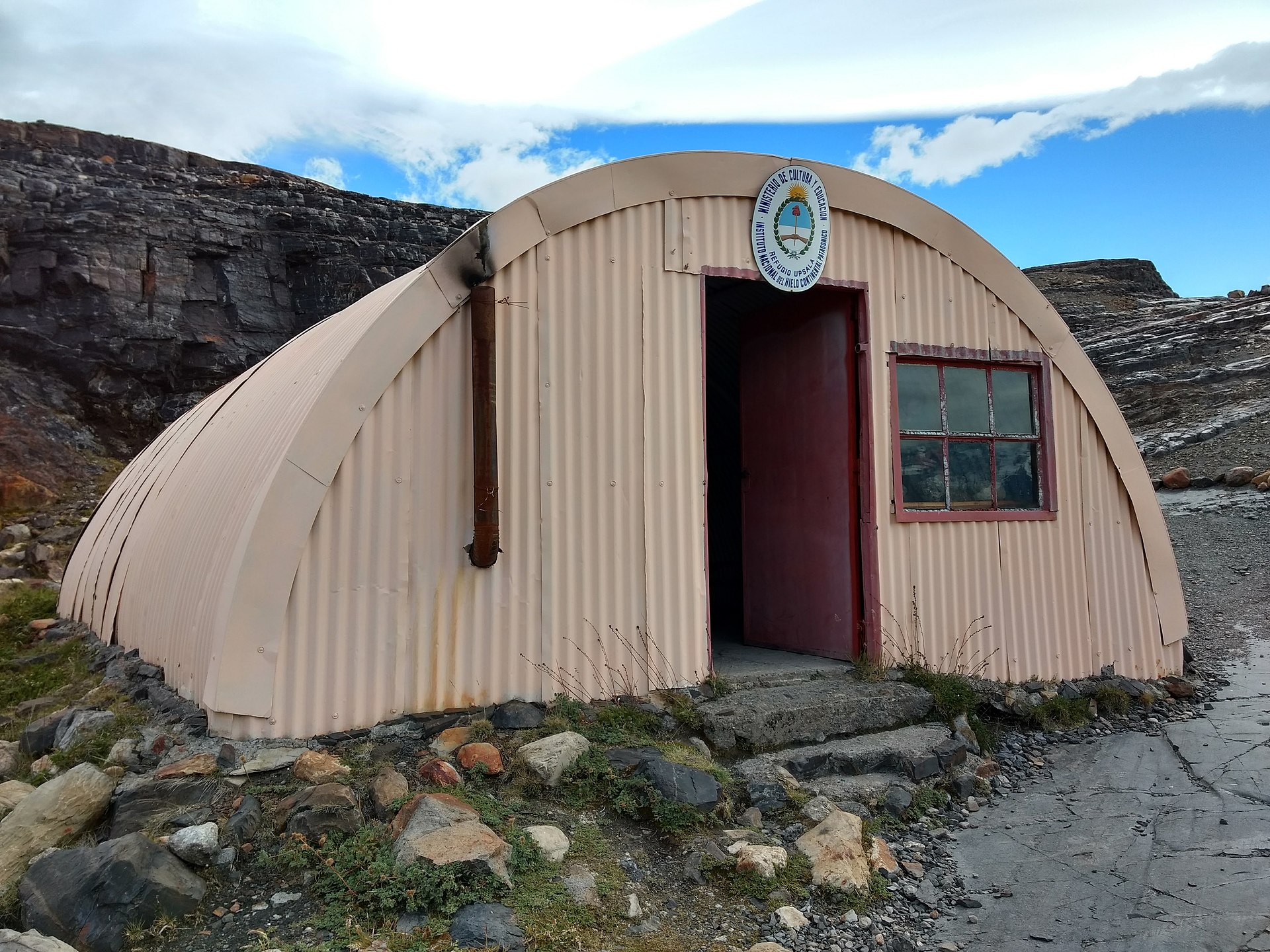 A small corrugated-metal mountain shelter in the Patagonian backcountry