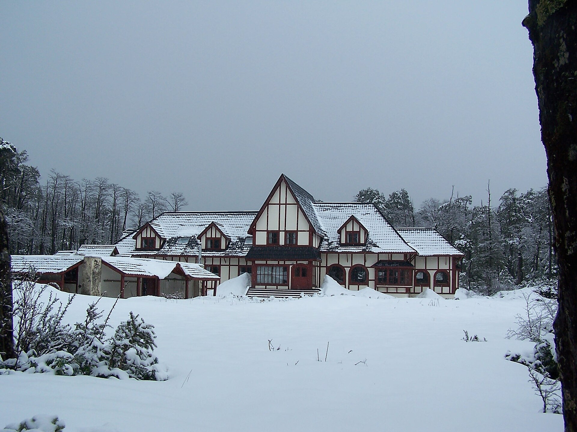 A timber mountain lodge surrounded by deep snow at Antillanca
