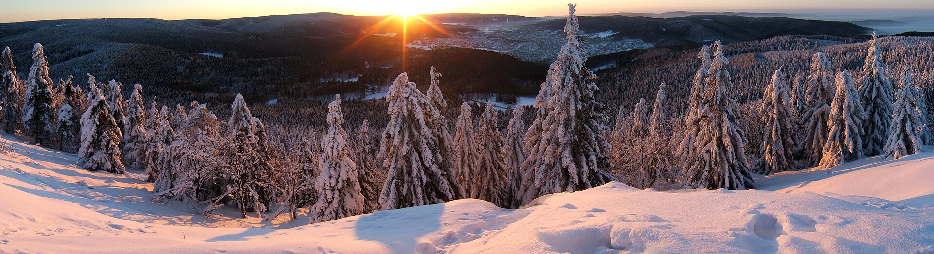 Pink winter sunrise over snowy hills in the Thuringian Forest