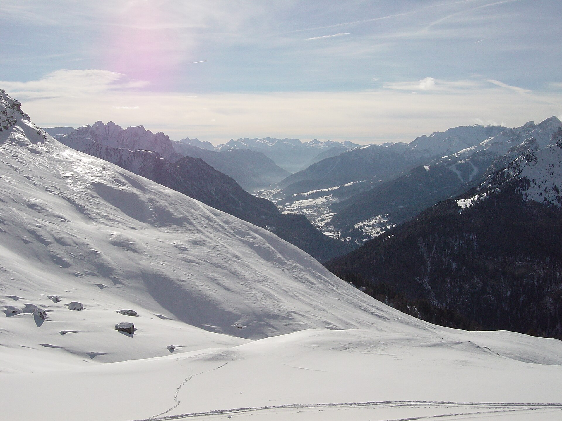 Snow-covered villages and rugged Dolomite peaks in Val di Fassa
